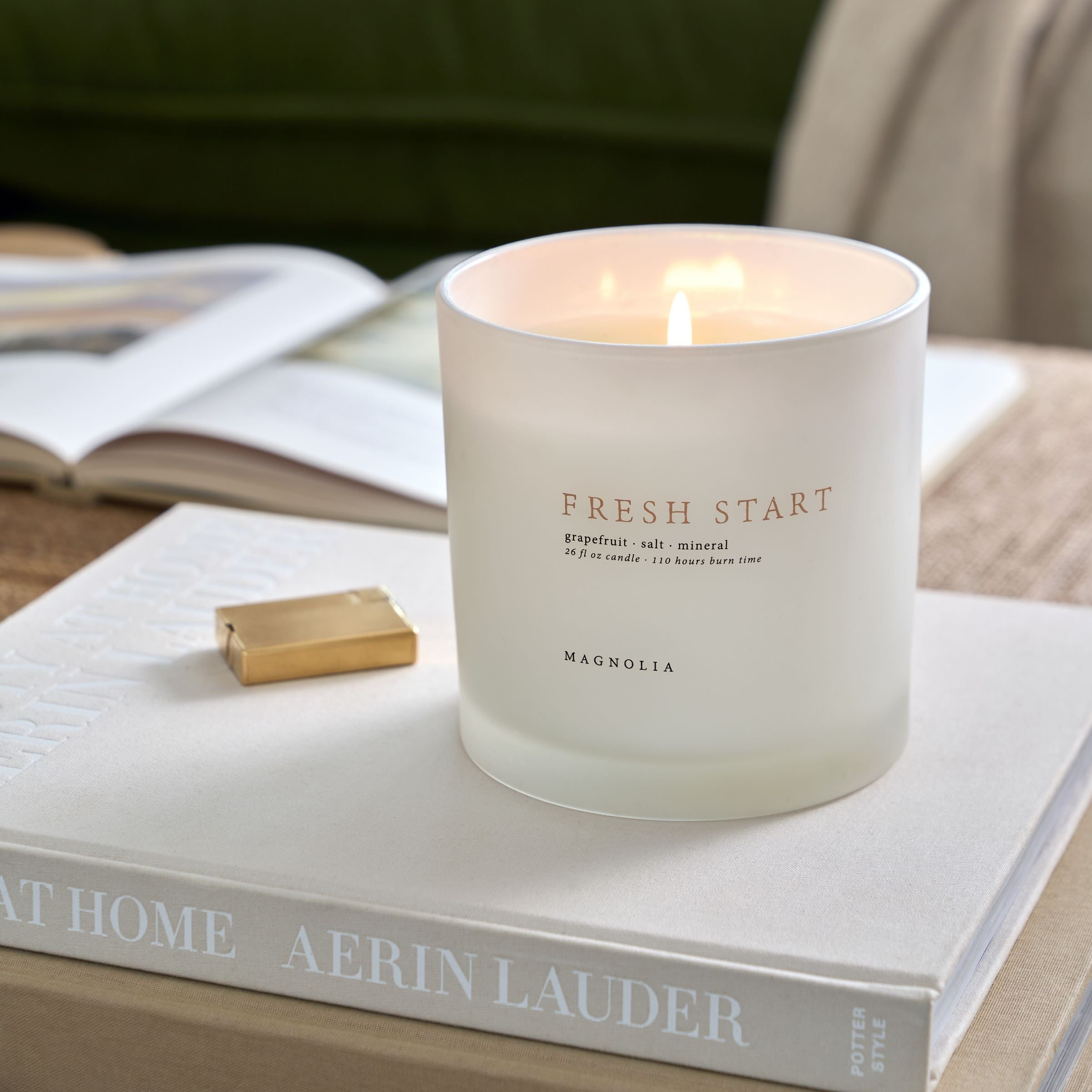 Magnoliass fresh start candle on stacked books
