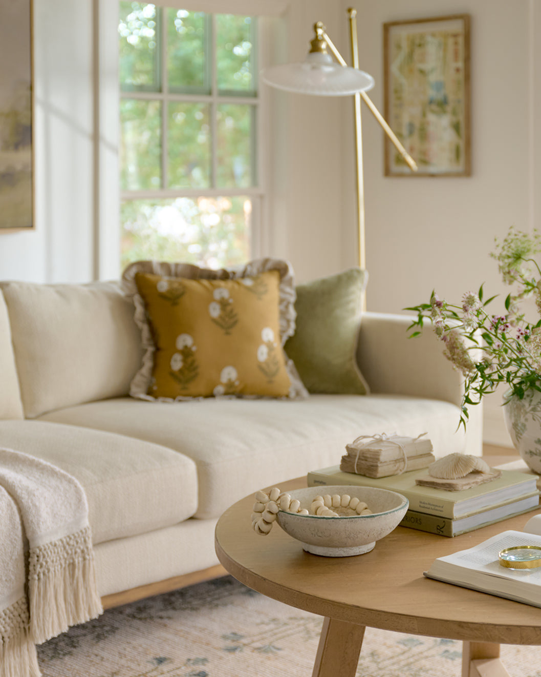 Living room with beige sofa, decorative pillows, and a wooden coffee table.