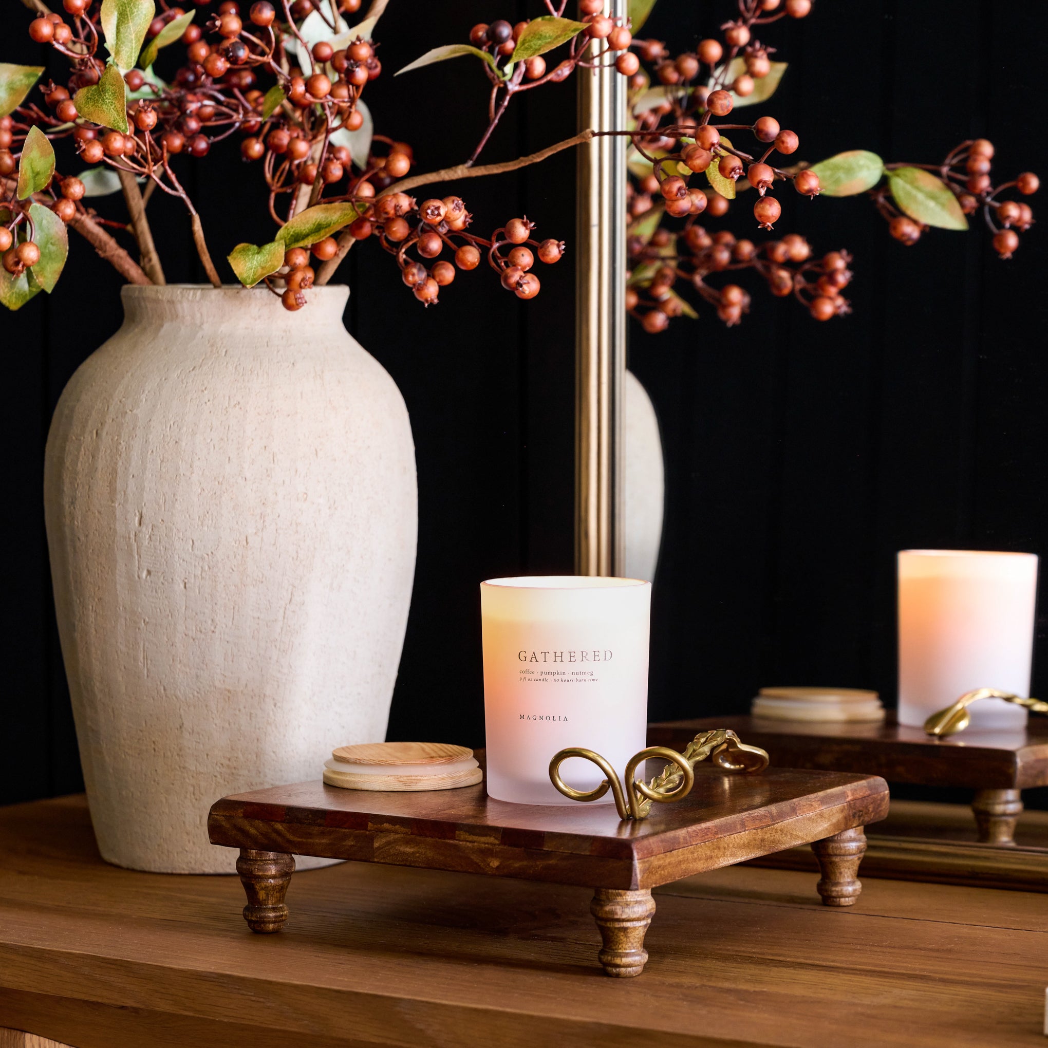 Magnoliass Gathered Candle on a serving board