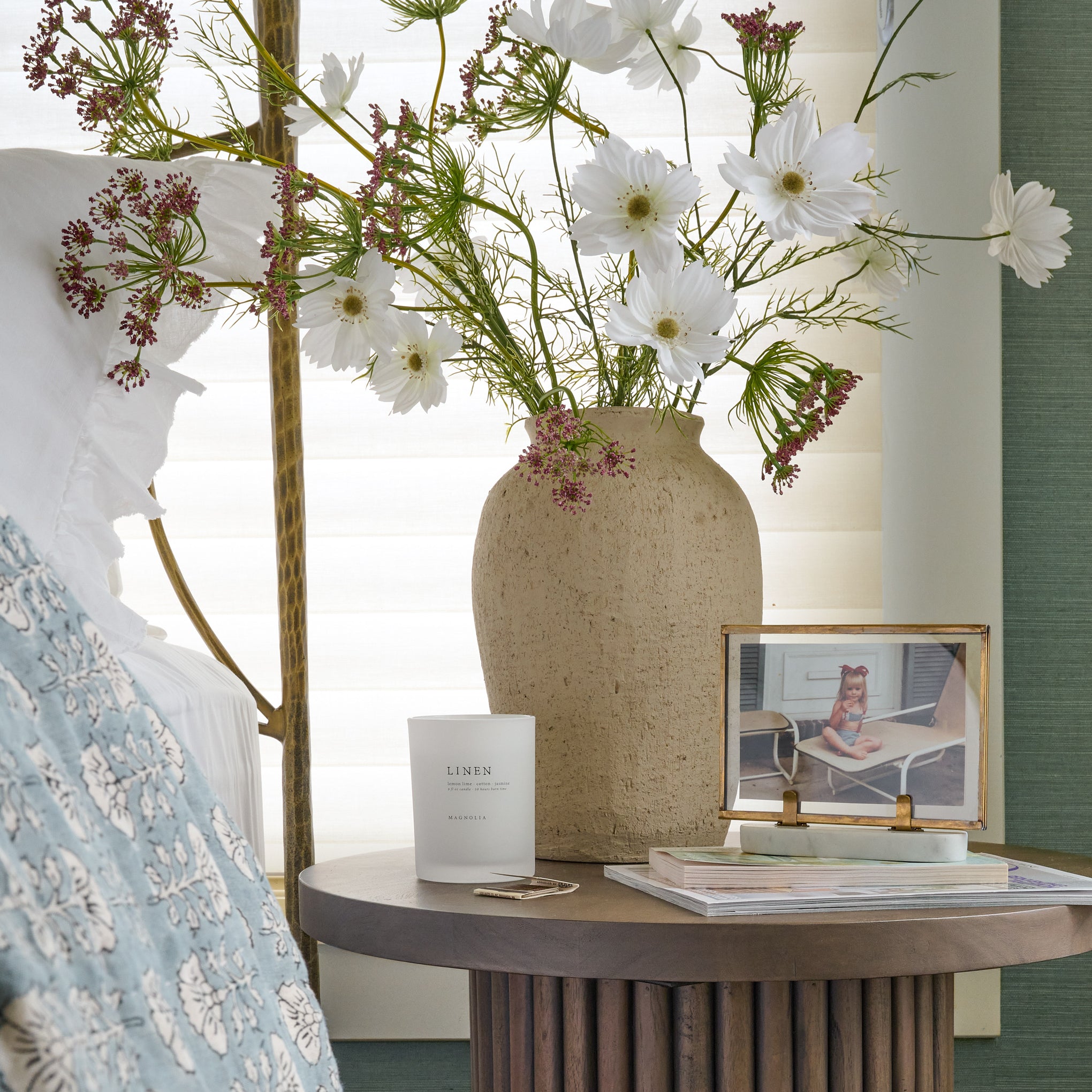 Small Textured Adrienne Vase on a bedside table next to a candle and framed photo