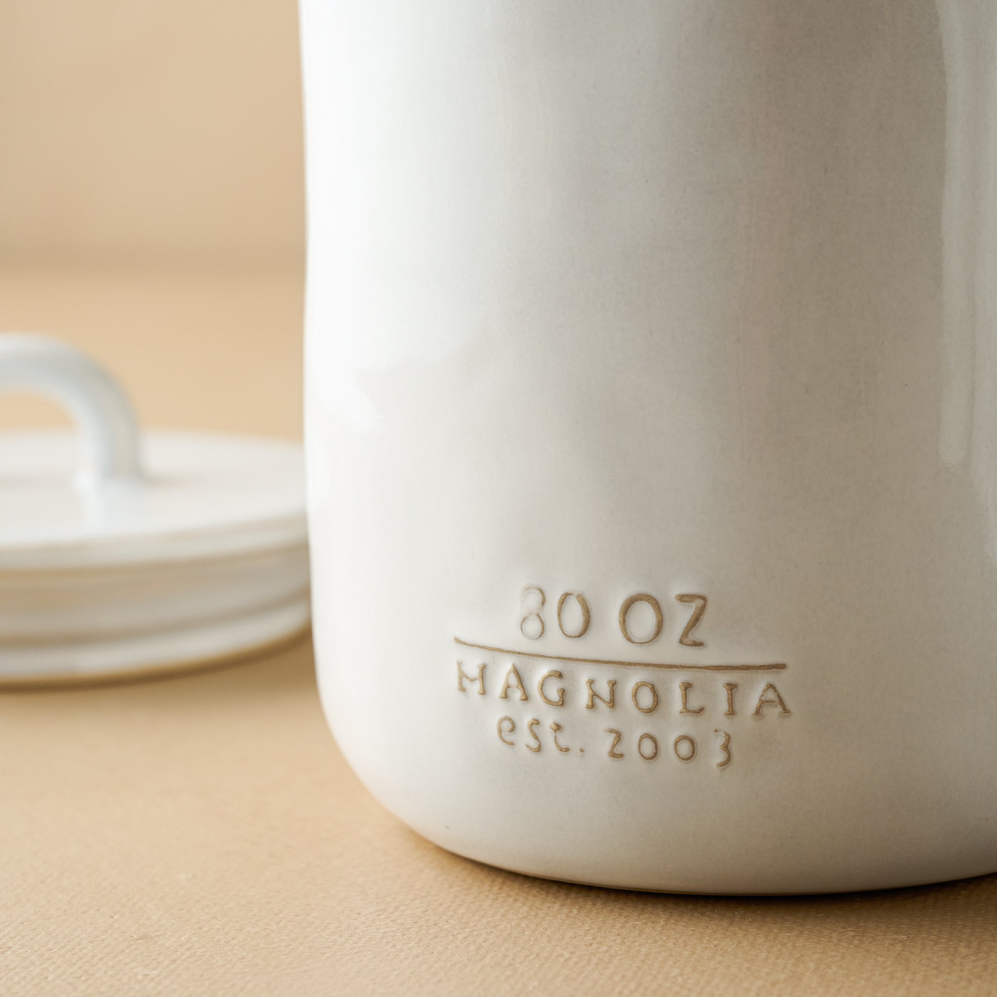 Mia Ceramic Canister close up of Magnoliass logo