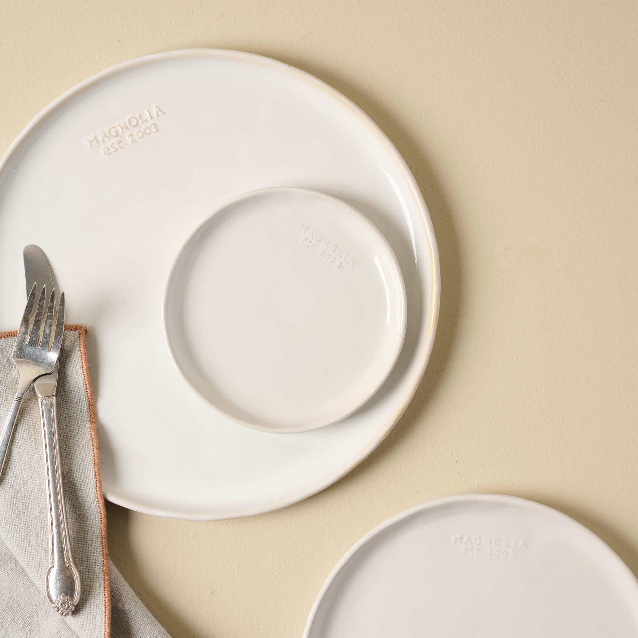 Magnoliass Est. Plates in all 3 sizes shown with silverware