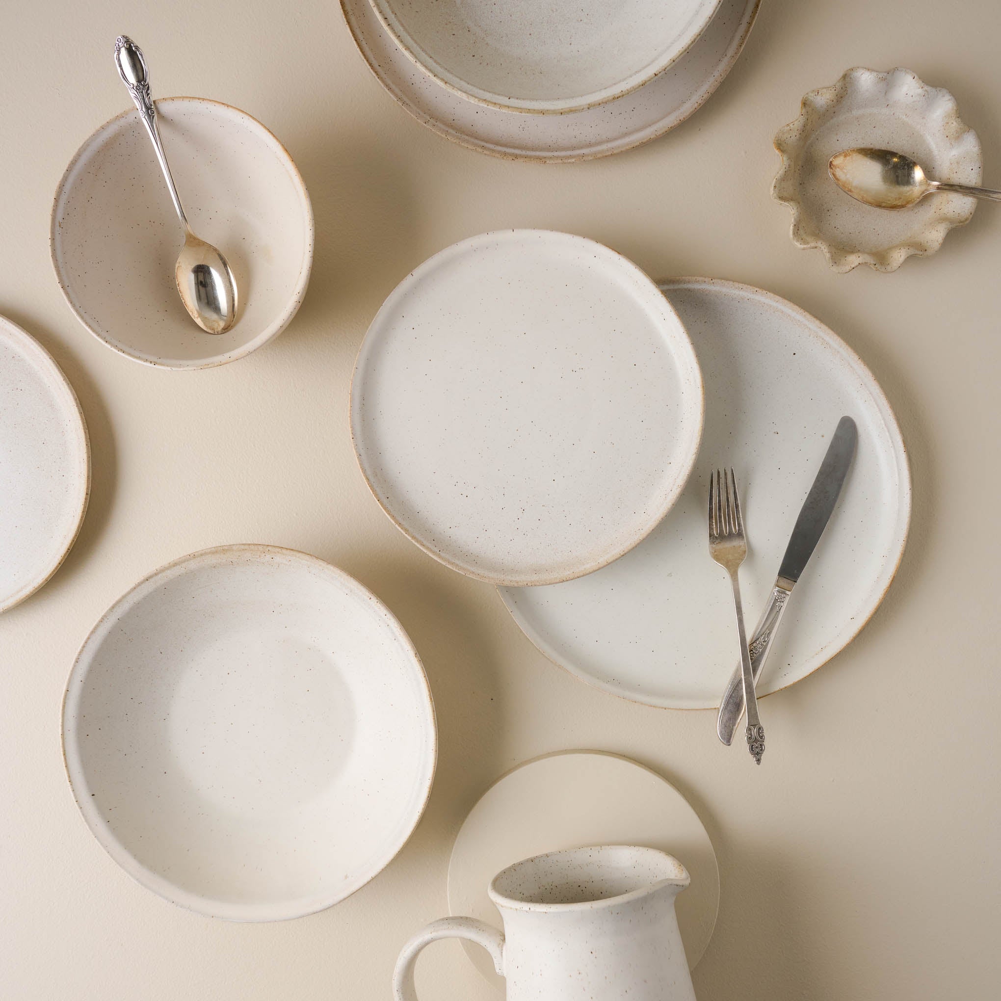 French White Speckle Plates with flatware on top