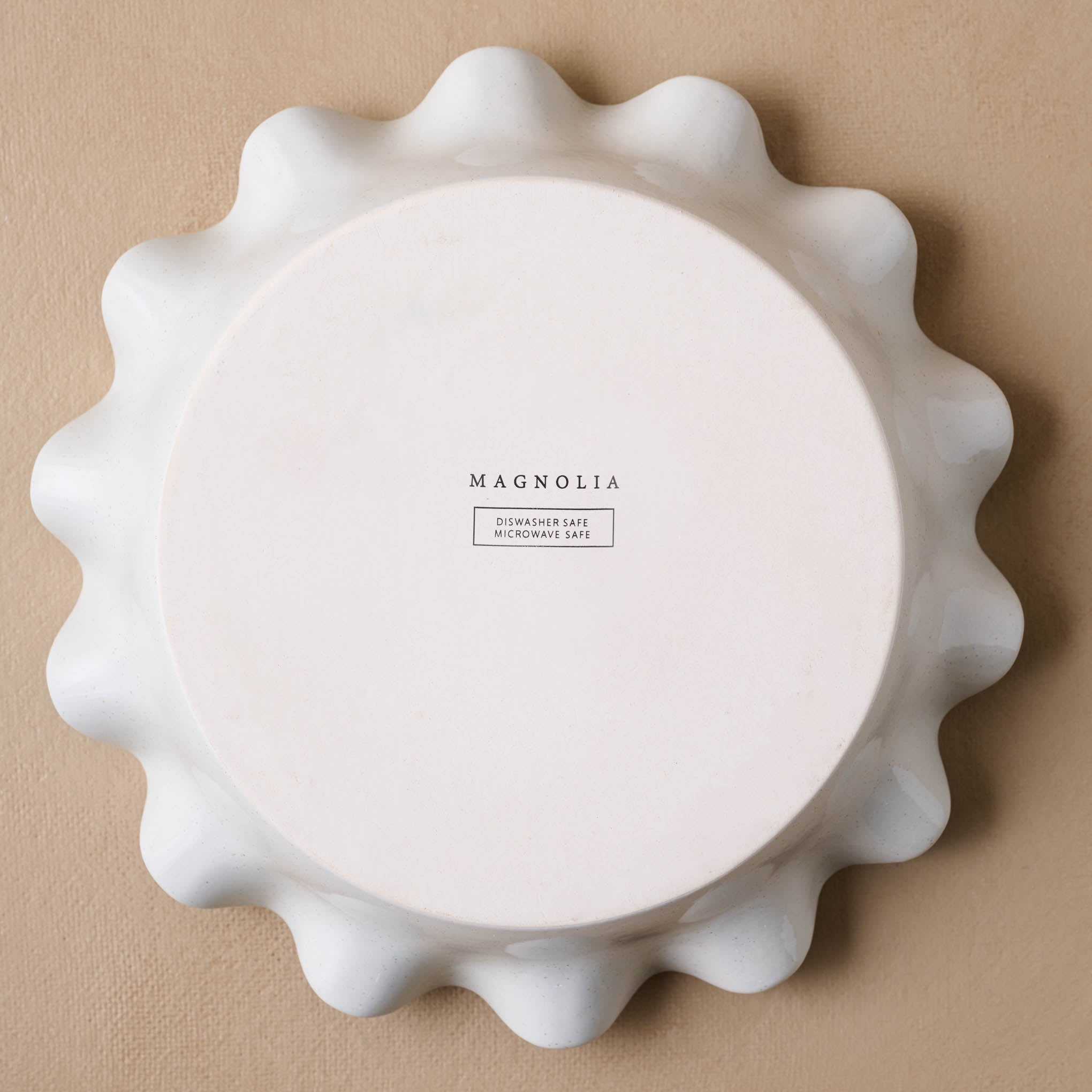 Cream Speckled Pie Dish upside down showing Magnoliass logo on bottom