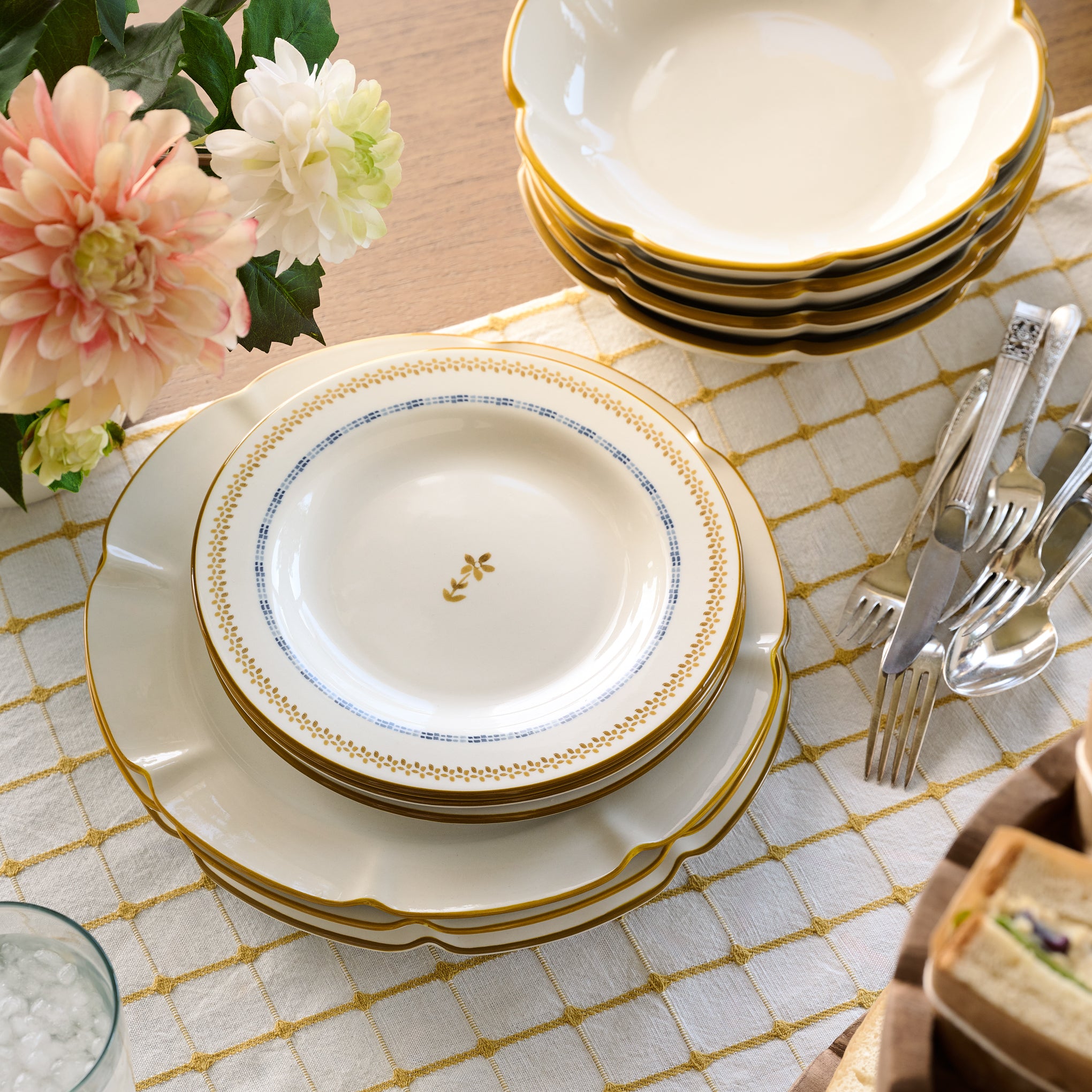 Luna Floral Salad Plate stacked on top of other plates on a tabletop