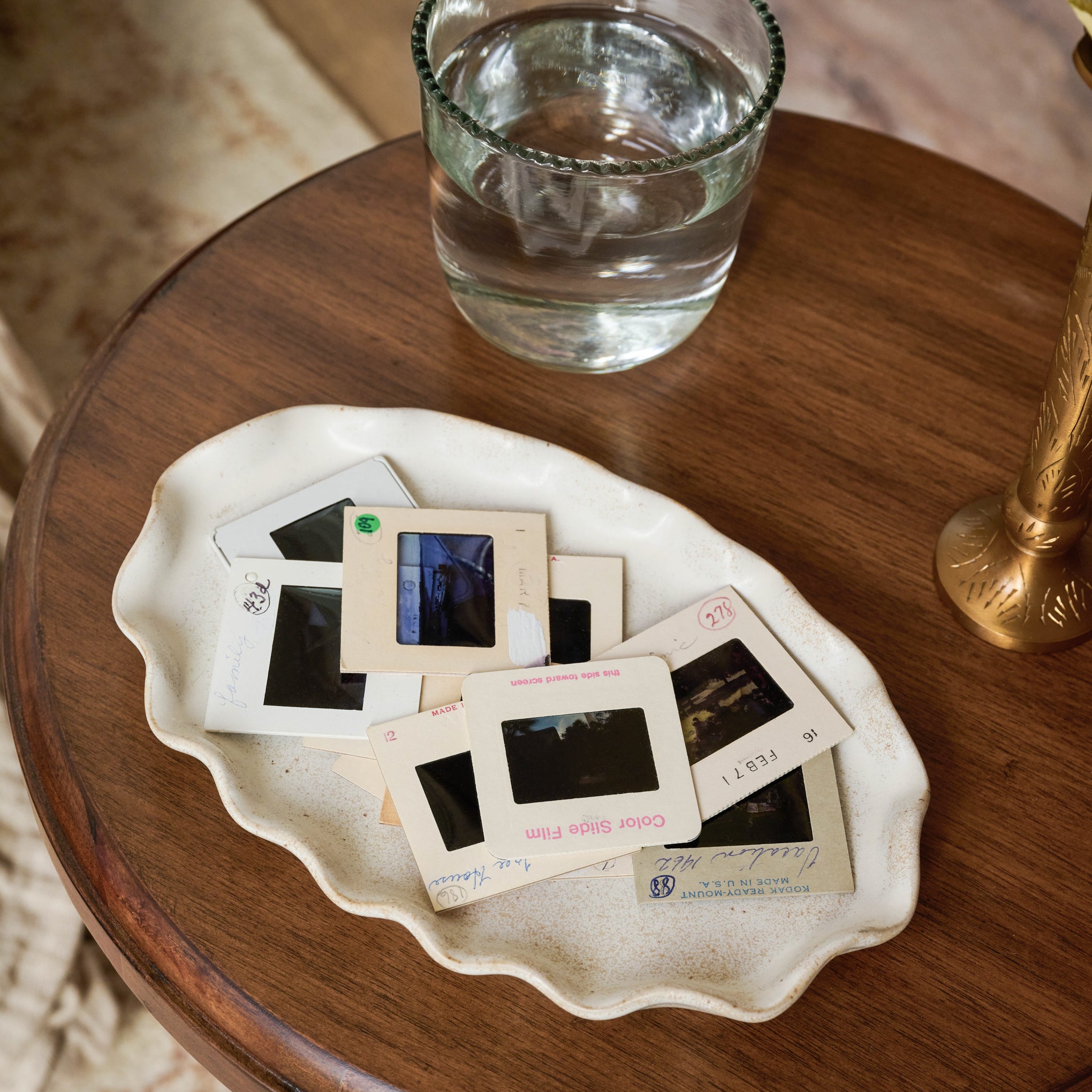 Ceramic Ruffled Tray on a table with photos on top