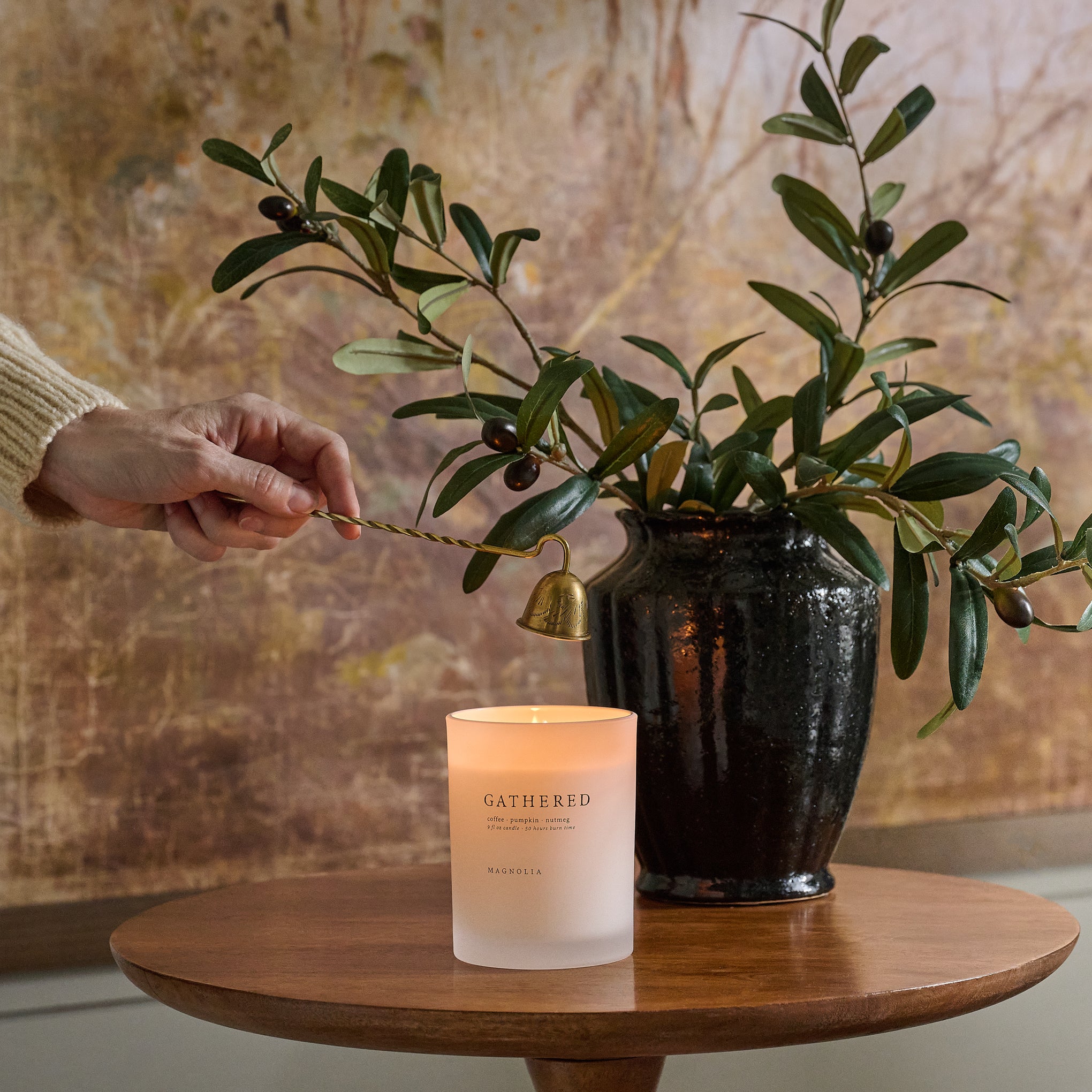 Magnoliass Gathered Candle shown being put out