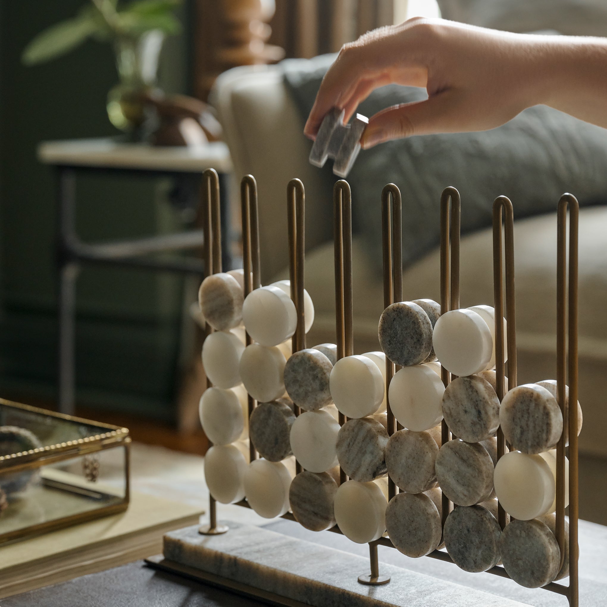 Marble Four In a Row Decorative Game shown being played