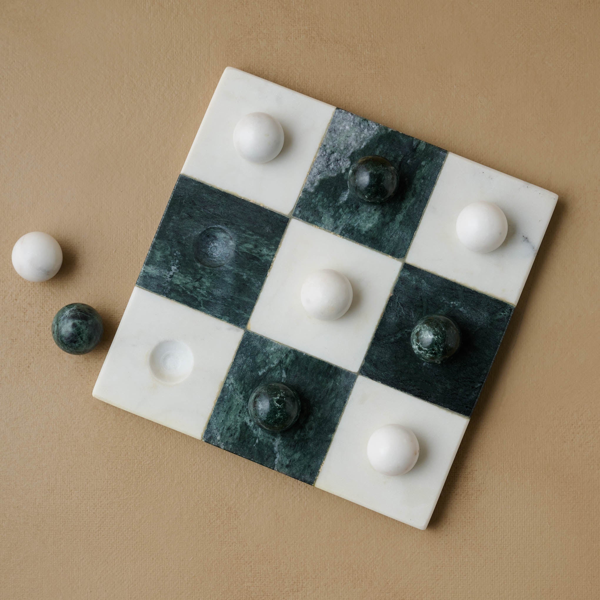 Green and White Marble Tic Tac Toe with two marble pieces on the side