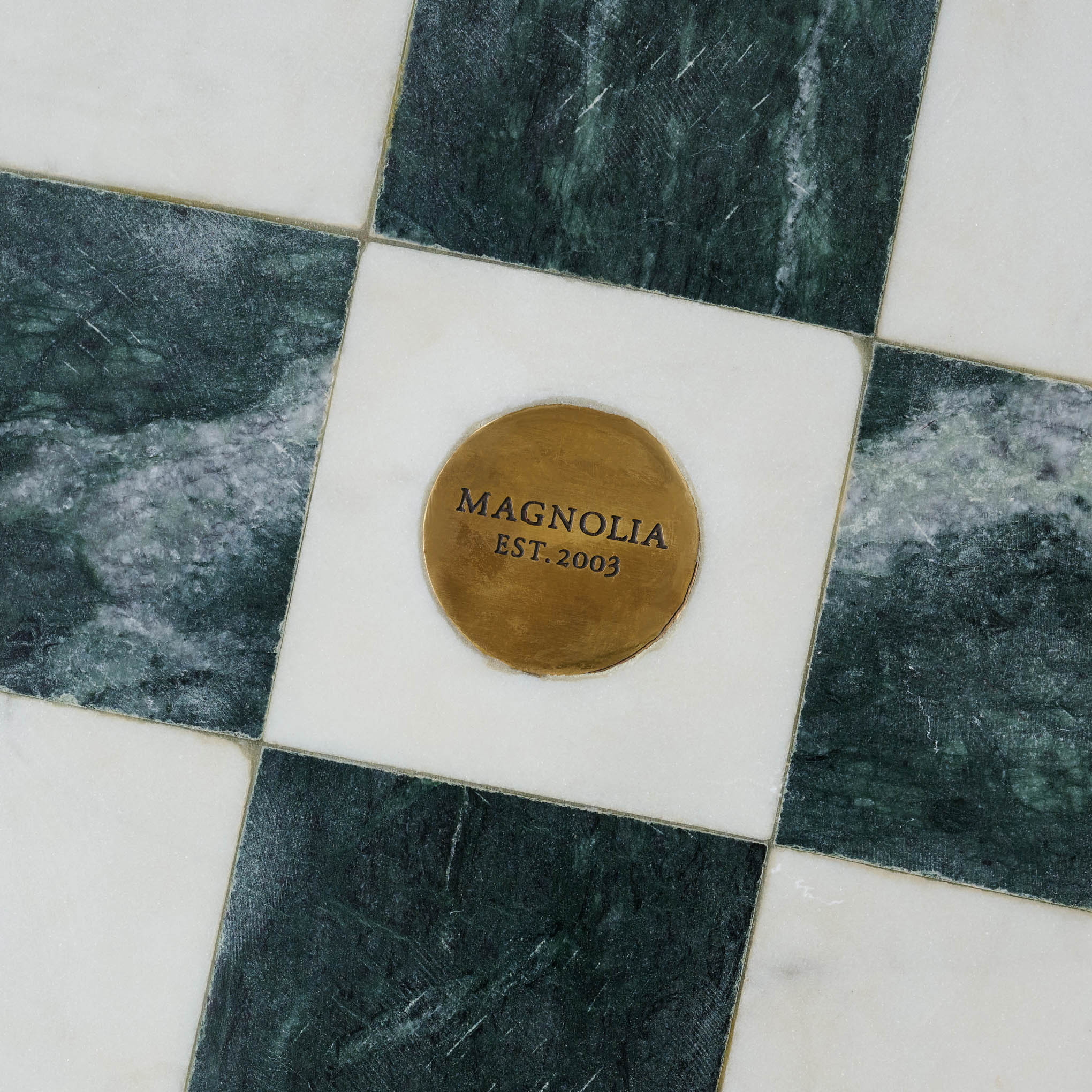 Green and White Marble Tic Tac Toe close up of Magnoliass logo on the bottom