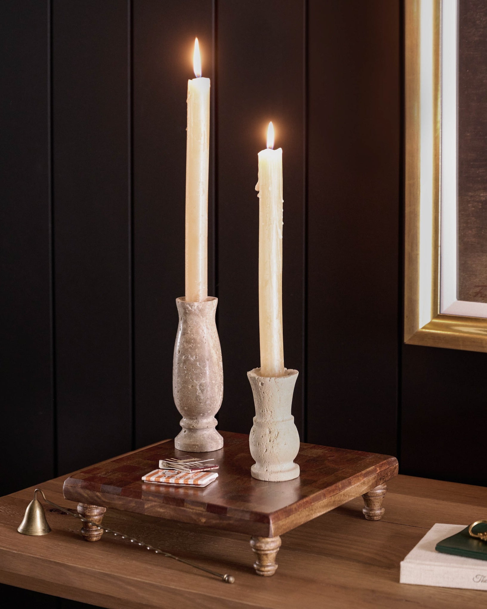 Checkered Wood Riser on a dresser with taper holders on top and candle sticks