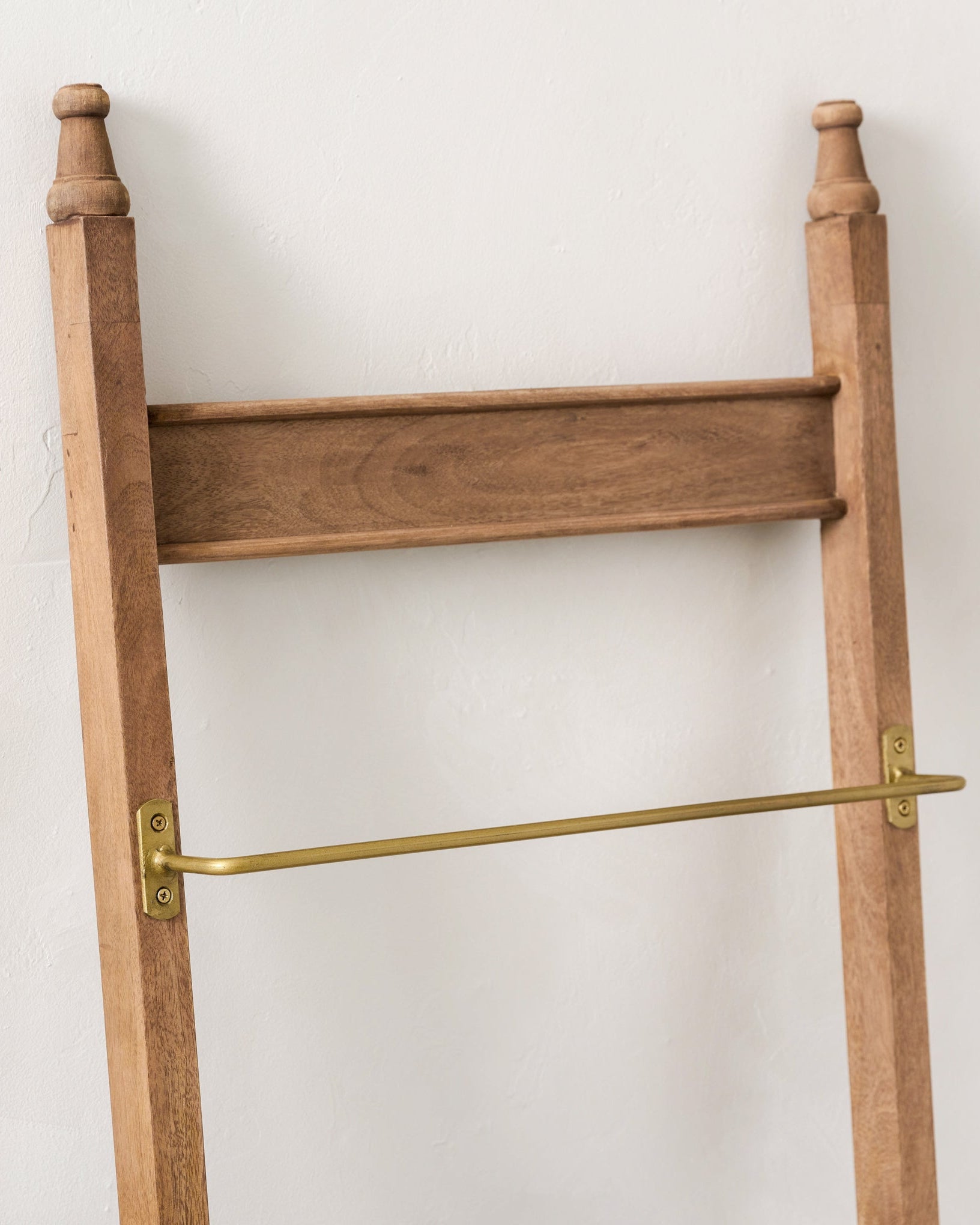Brass and Wood Library Ladder against a wall - close up of top of ladder