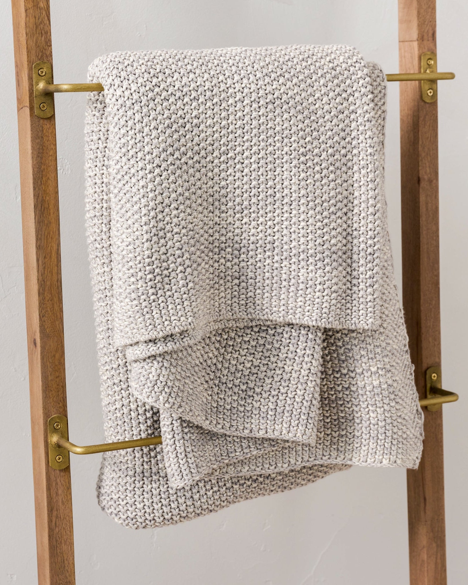 Brass and Wood Library Ladder close up of blanket hanging on ladder