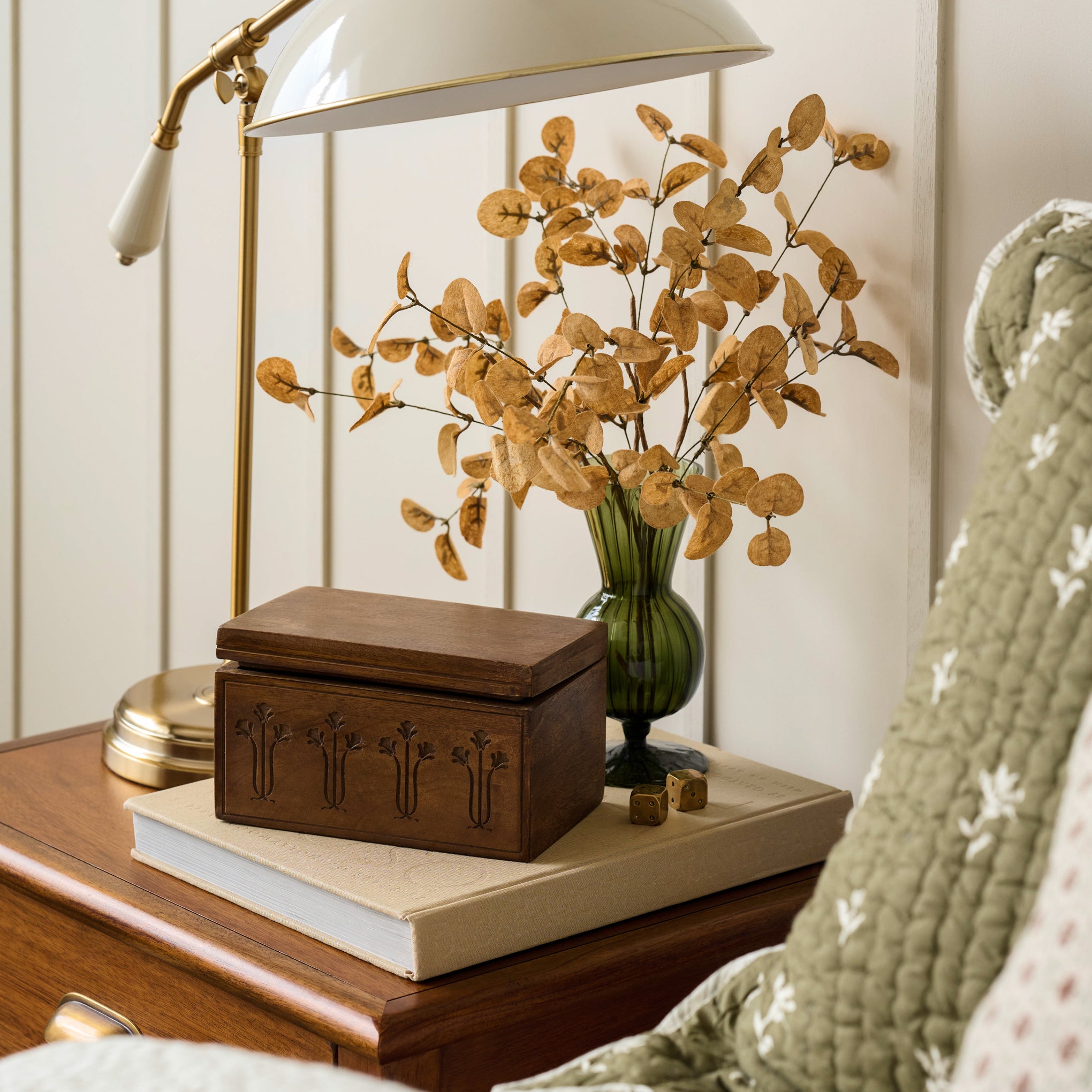 Fluted Green Glass Vase shown holding flowers on bedside table