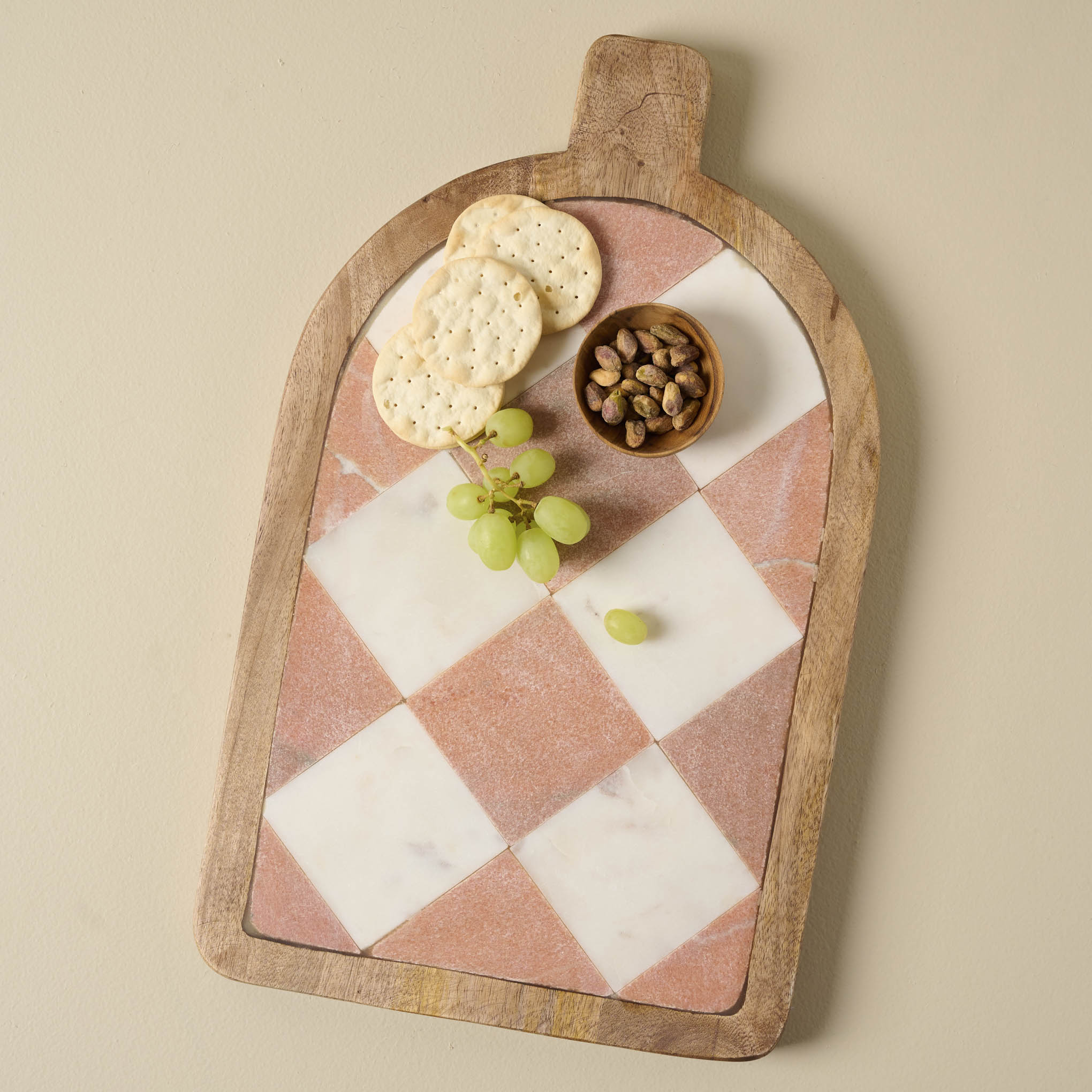 Carmella Checkered Marble Serving Board with nutes, grapes, and crackers on top