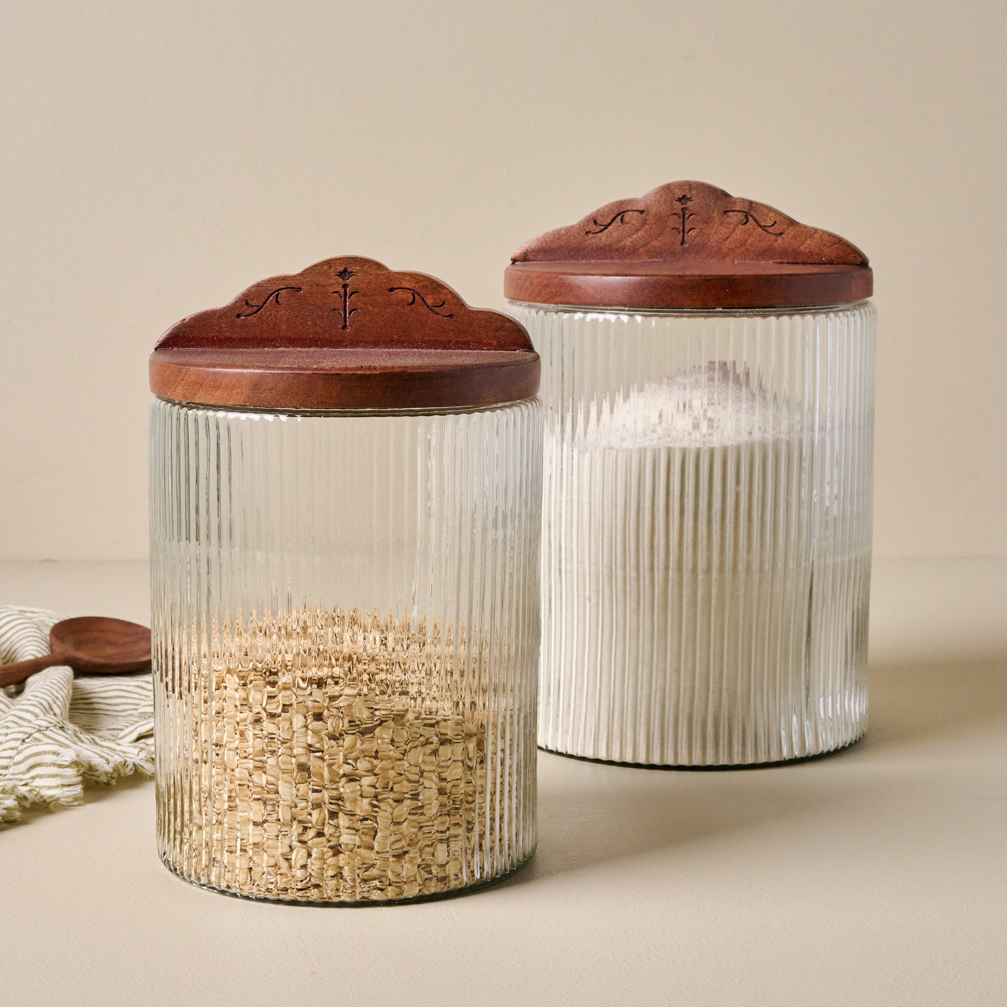 Small and Large Antiqued Wood Ribbed Glass Canisters filled with oats  and flour