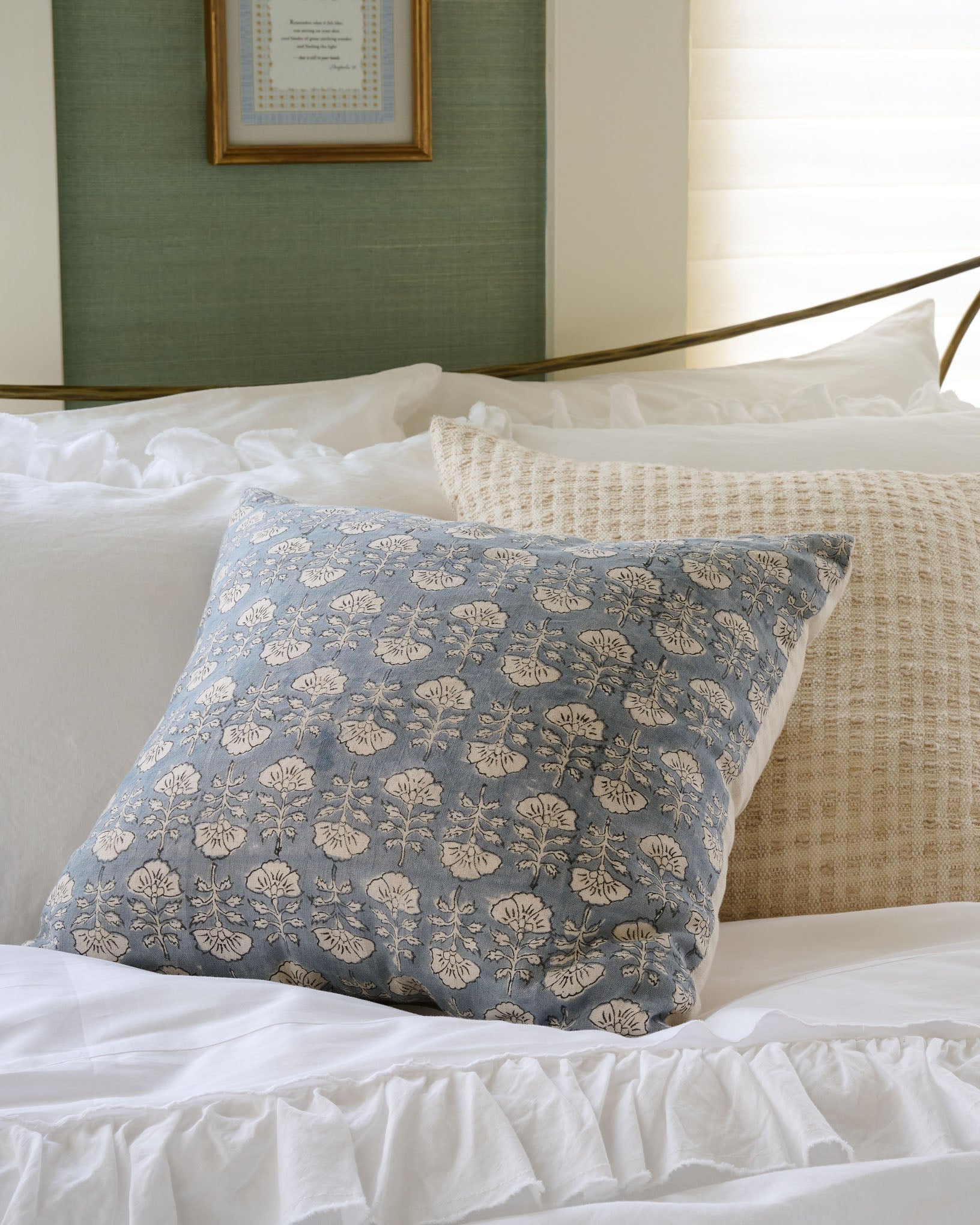 Flora Silver Blue Printed Pillow on a made bed