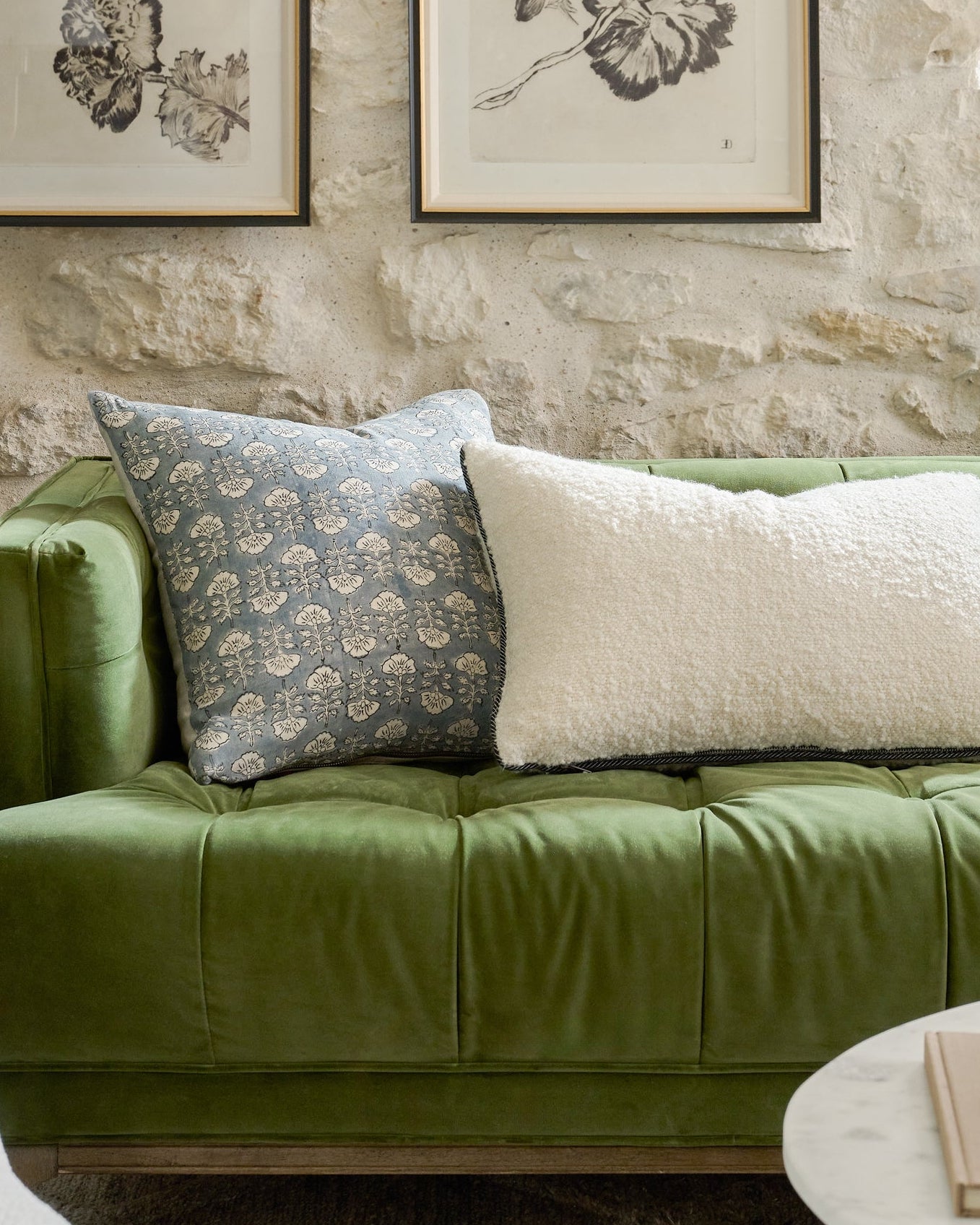 Flora Silver Blue Printed Pillow on a green sofa
