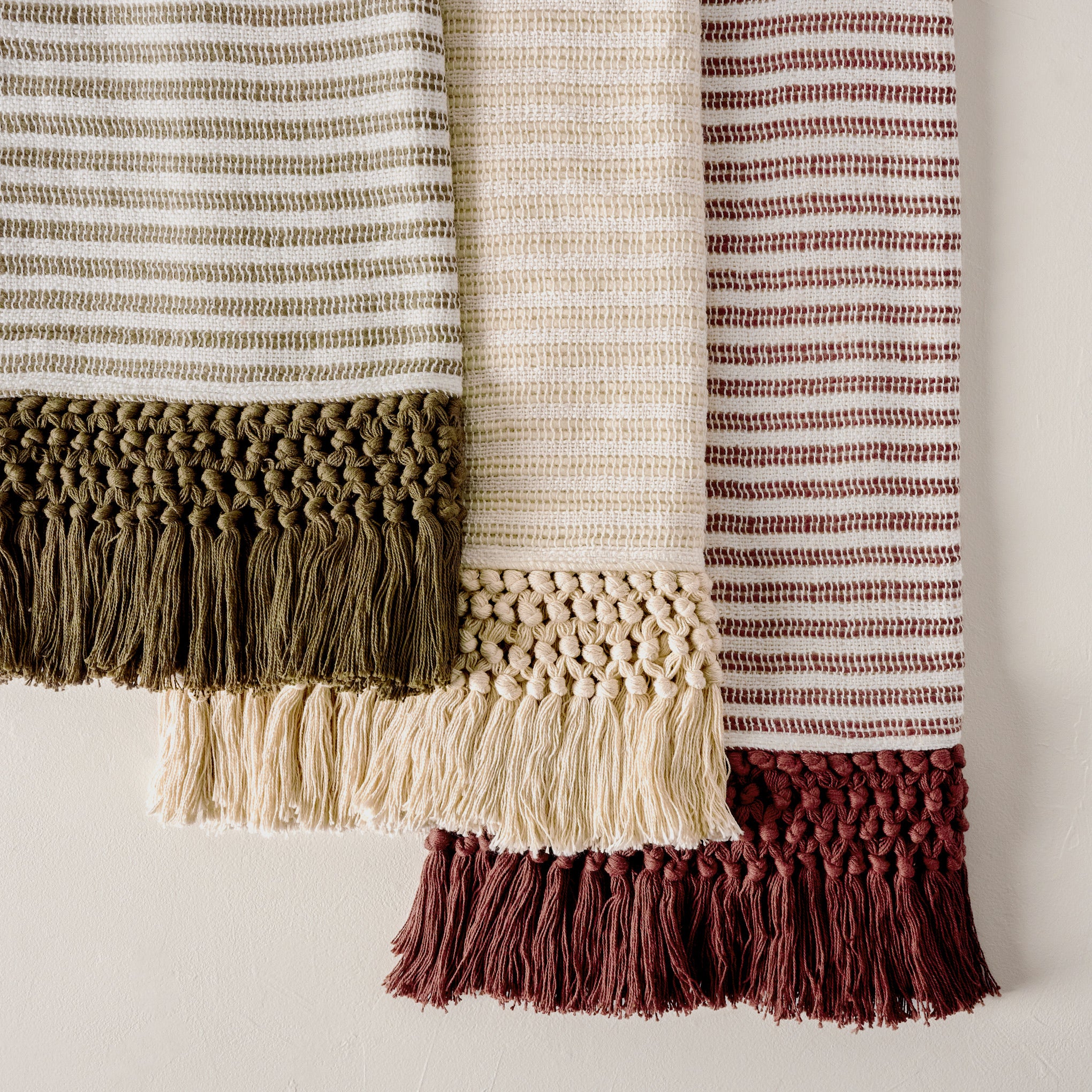 Essential Tassel Throw - Burgundy Striped shown with cream and green throws