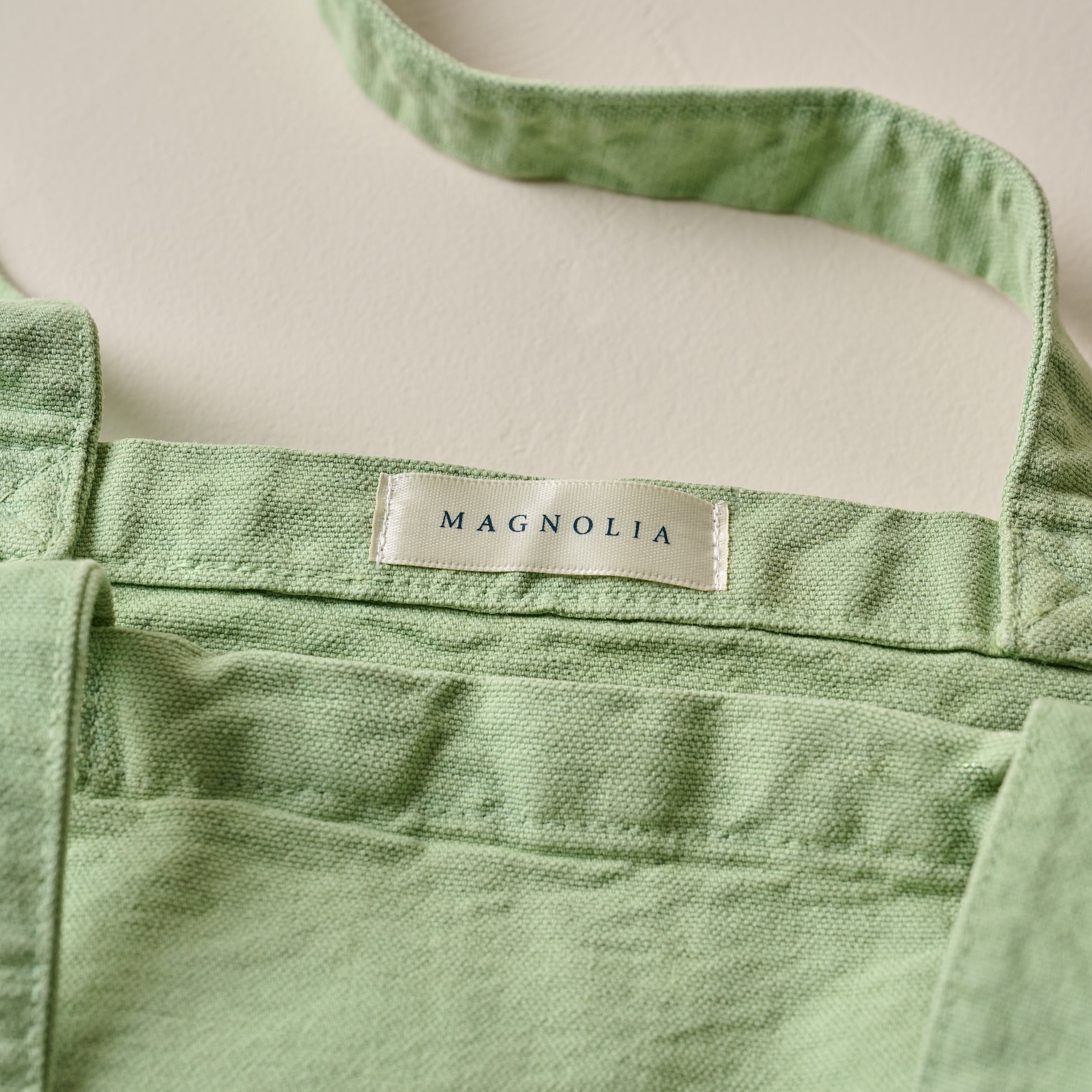 Magnoliass Seafoam Script Tote close up of Magnoliass logo tag