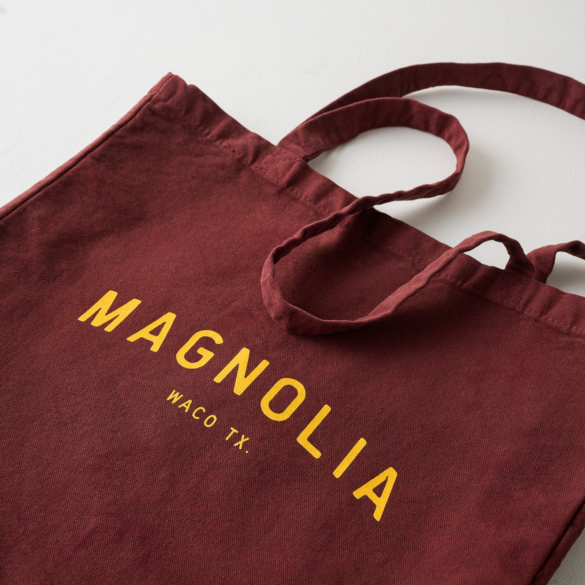 Magnoliass Burgundy Arched Tote up close