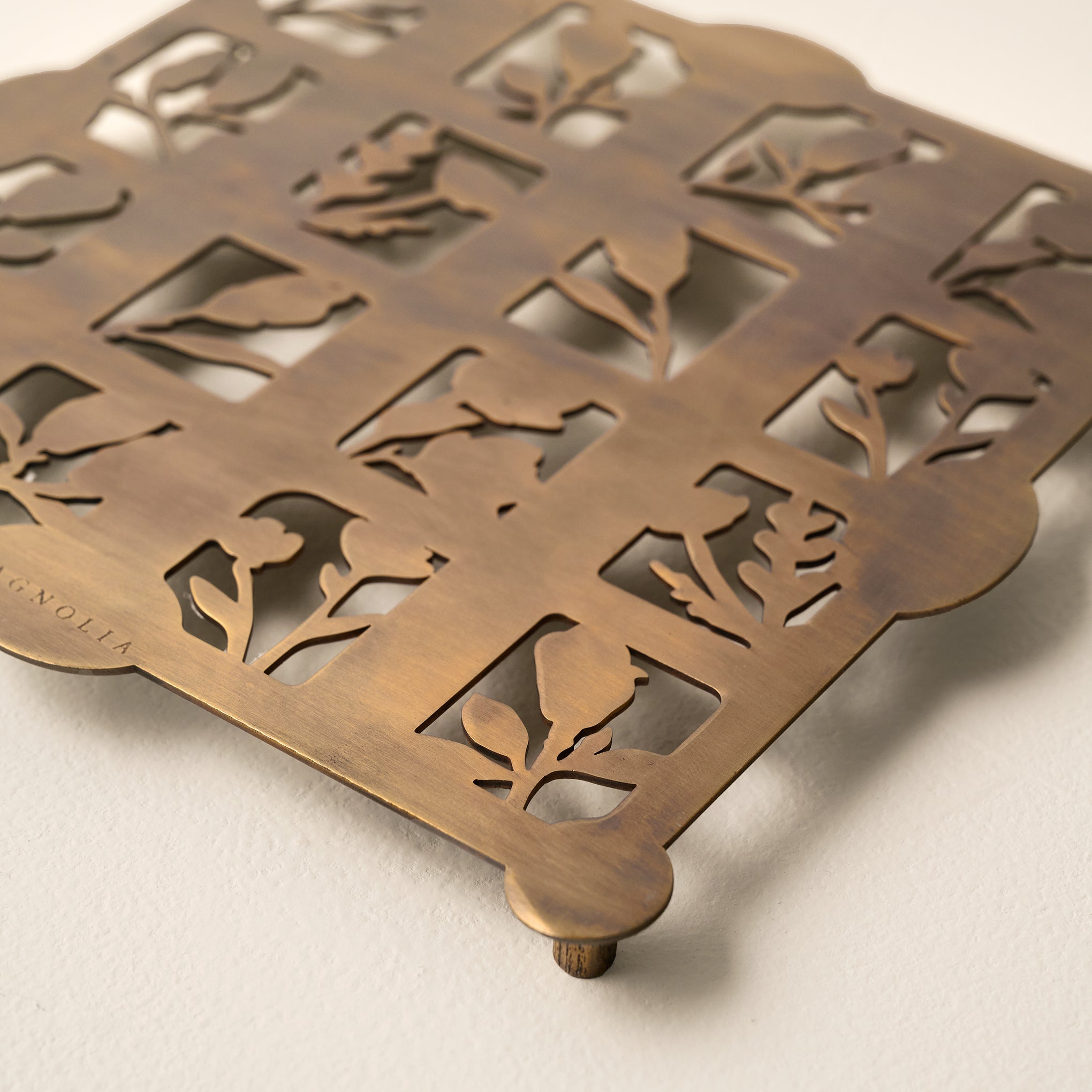 Antique Brass Shadow Floral Trivet shown up close