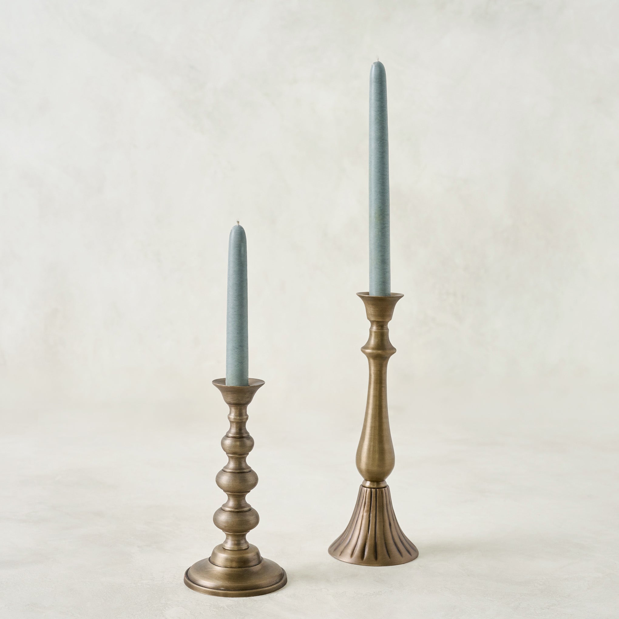 Faris Antiqued Brass Candleholder shown with candles