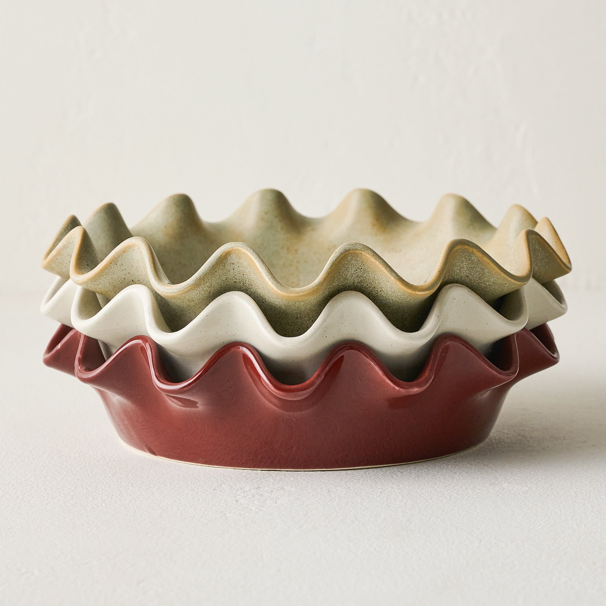 Cream Speckled Pie Dish shown stacked with pie dishes