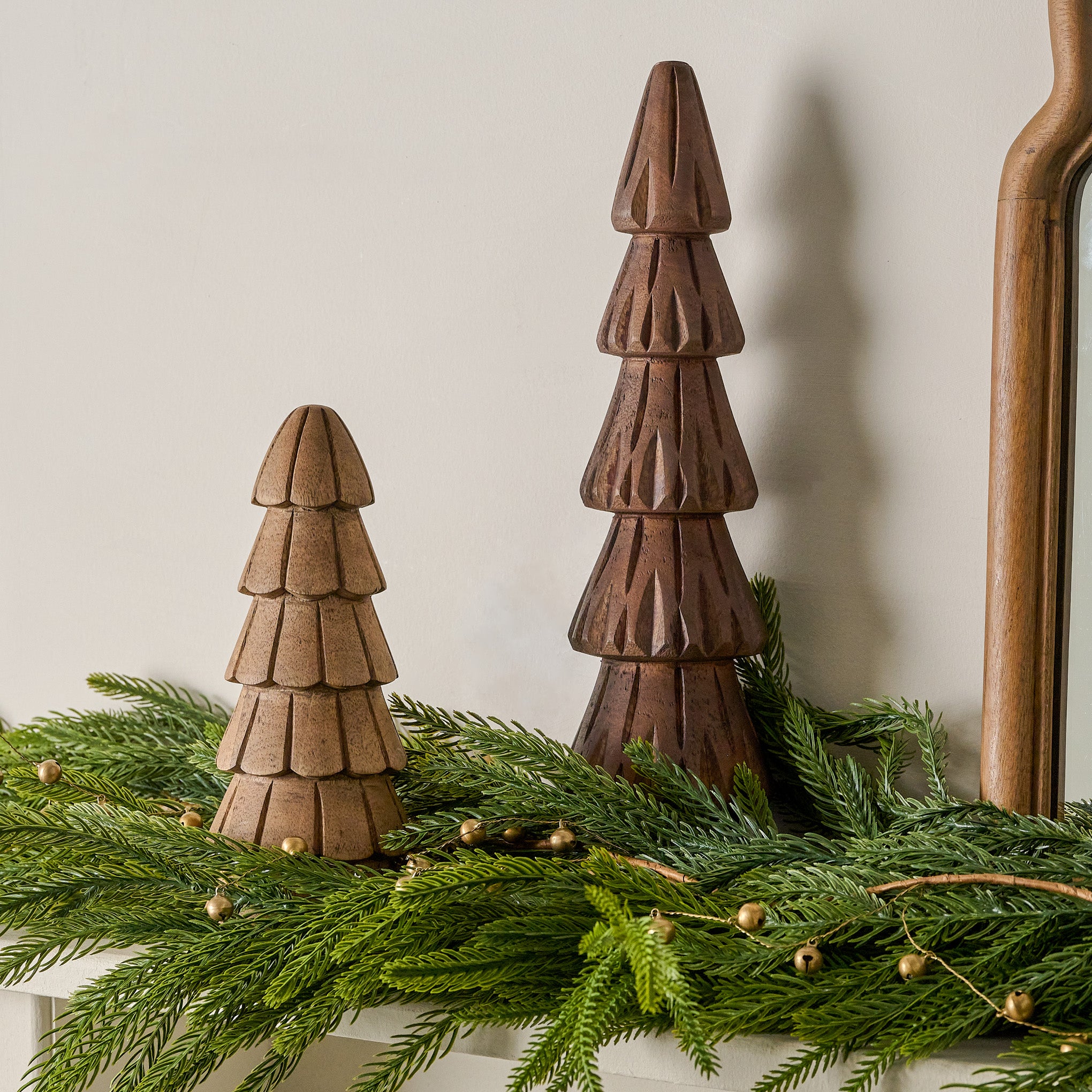 Hand Carved Woodland Trees shown on mantel with greenery