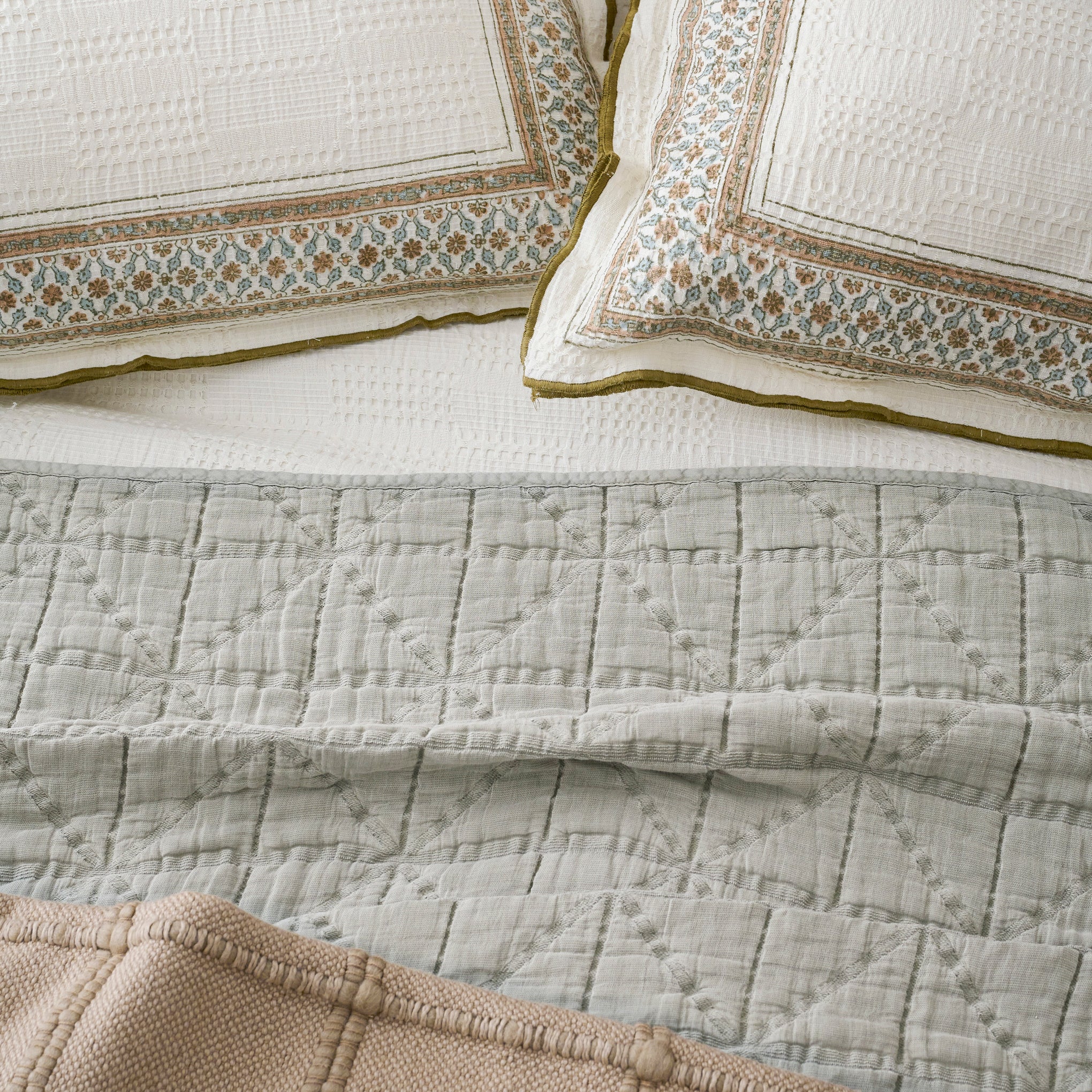 Clemence Block Print Sham shown on bed with quilt