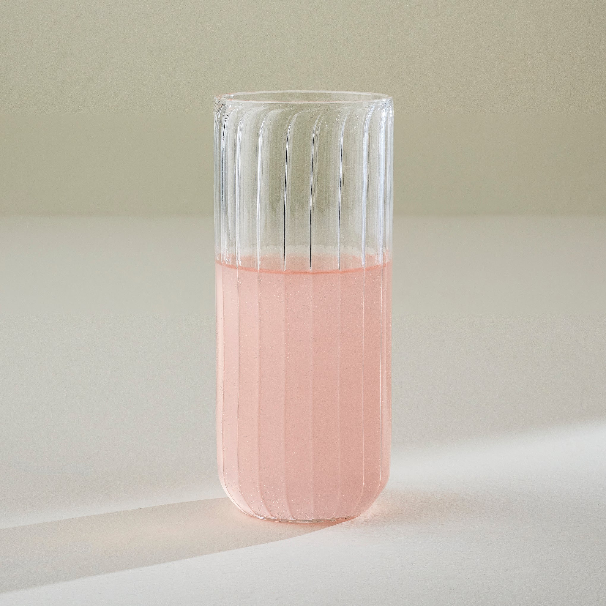 Fluted Glass Tumbler shown with drink