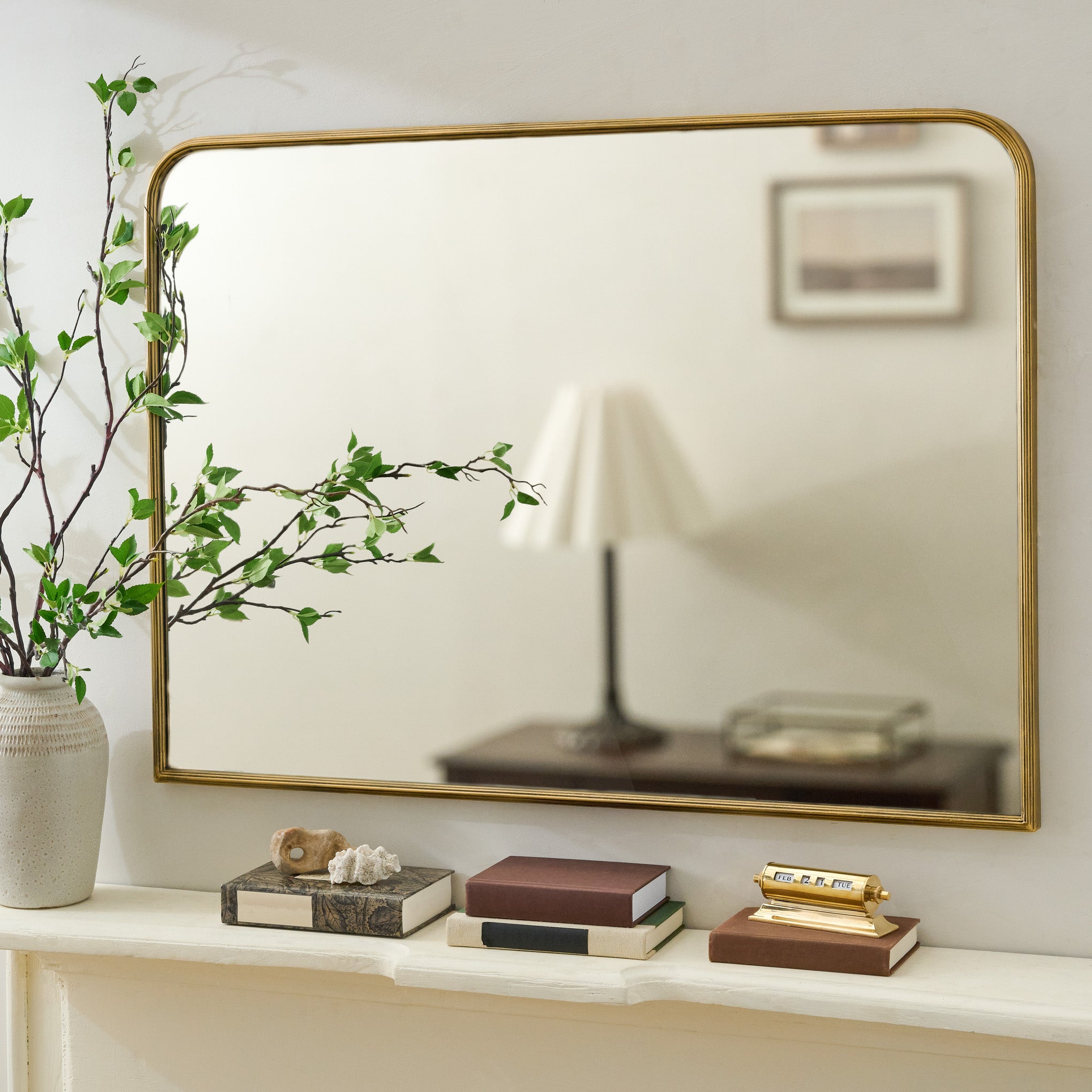 Collin Ribbed Brass Mantel Mirror shown above mantel