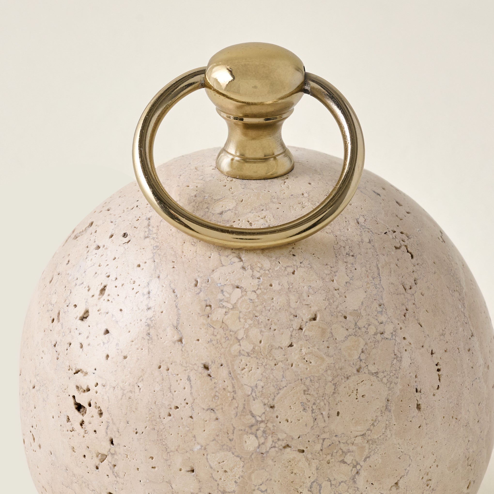 Travertine and Brass Doorstop up close