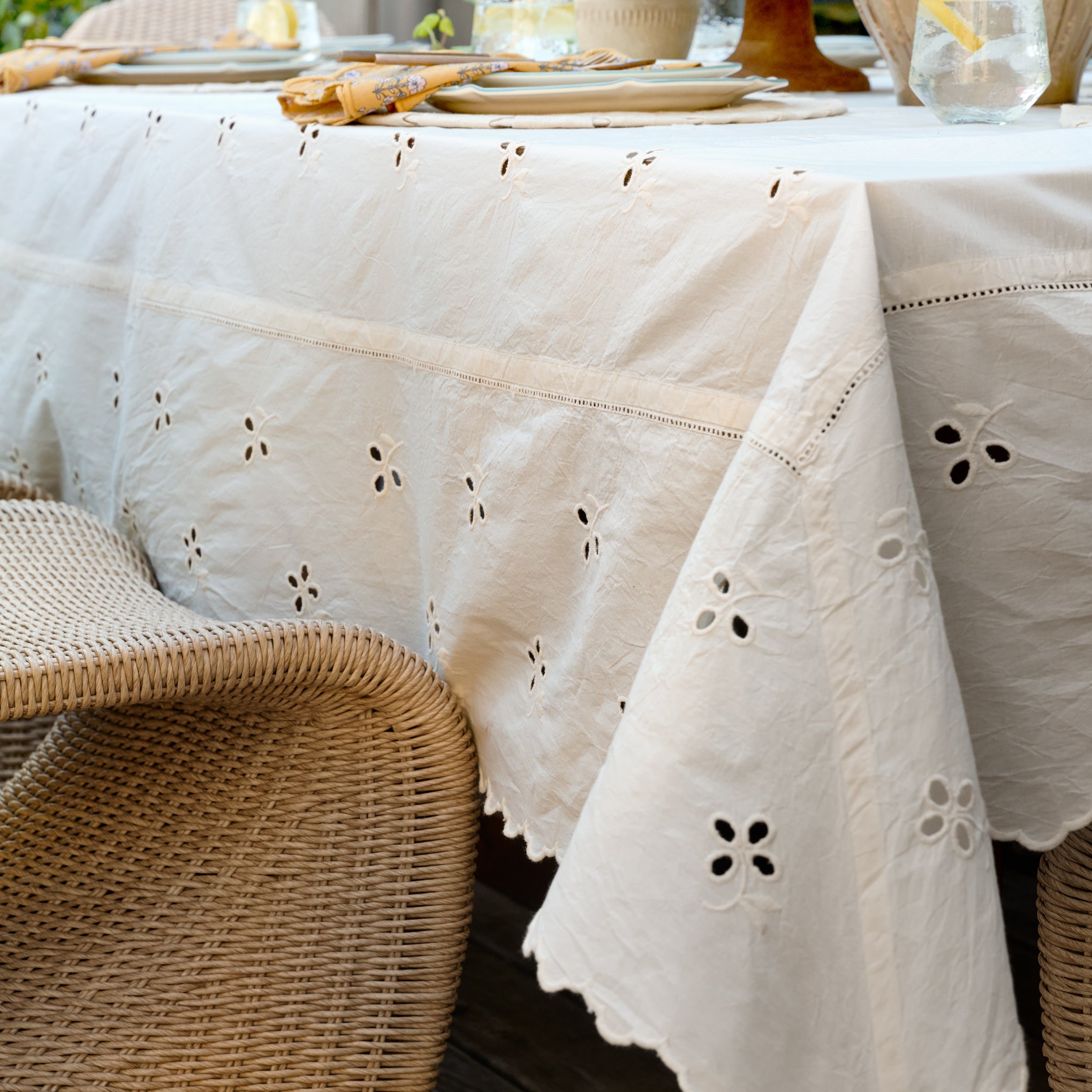 Antique White Eyelet Tablecloth up close shown on table outside