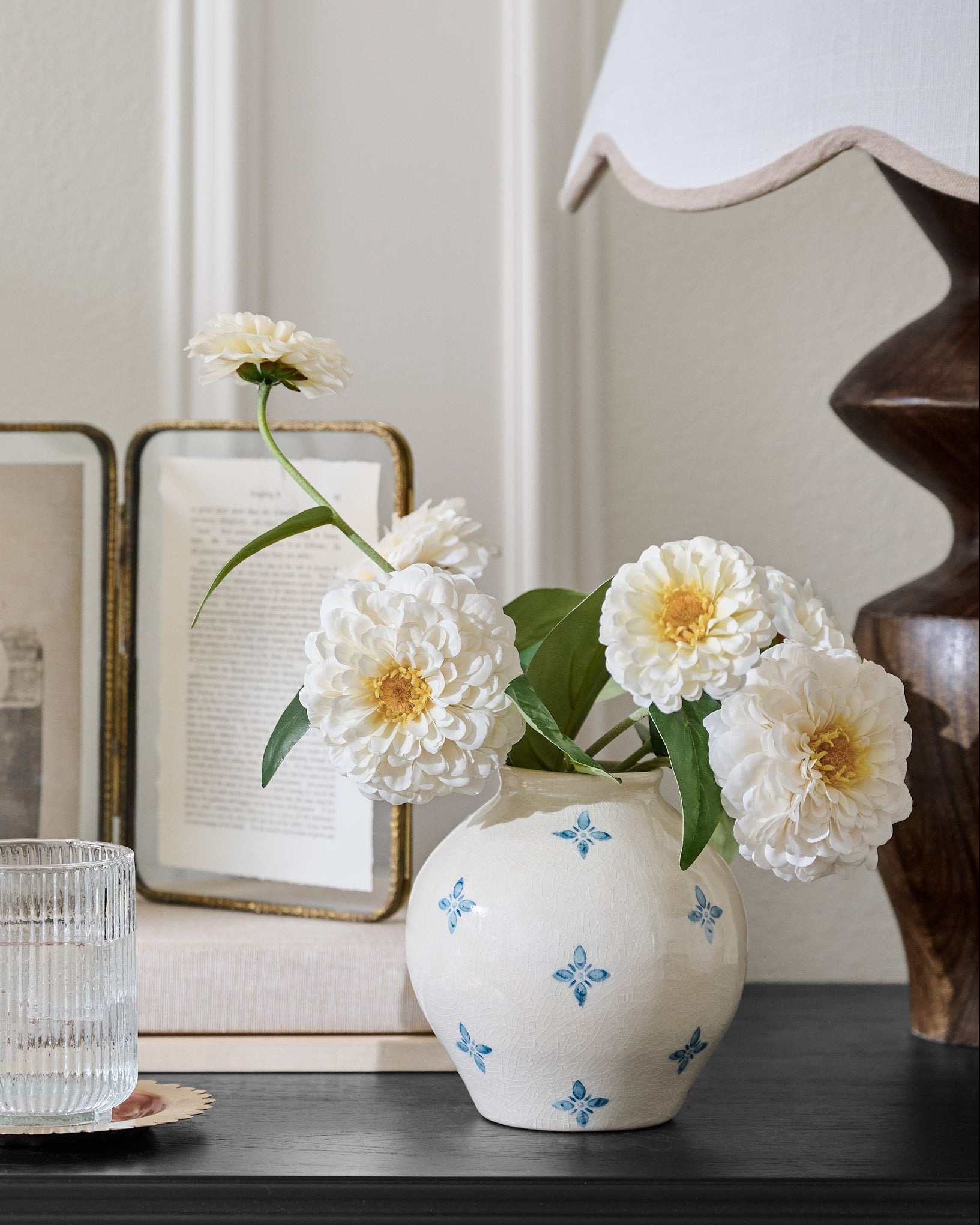 Real Touch Cream Zinnia shown in vase on nightstand