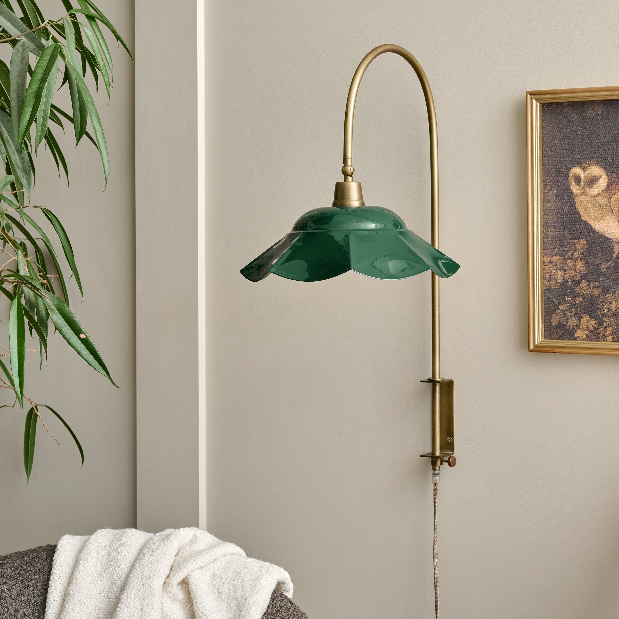 Mary Enamel Plug-in Sconce Dark Green with Brass shown on wall
