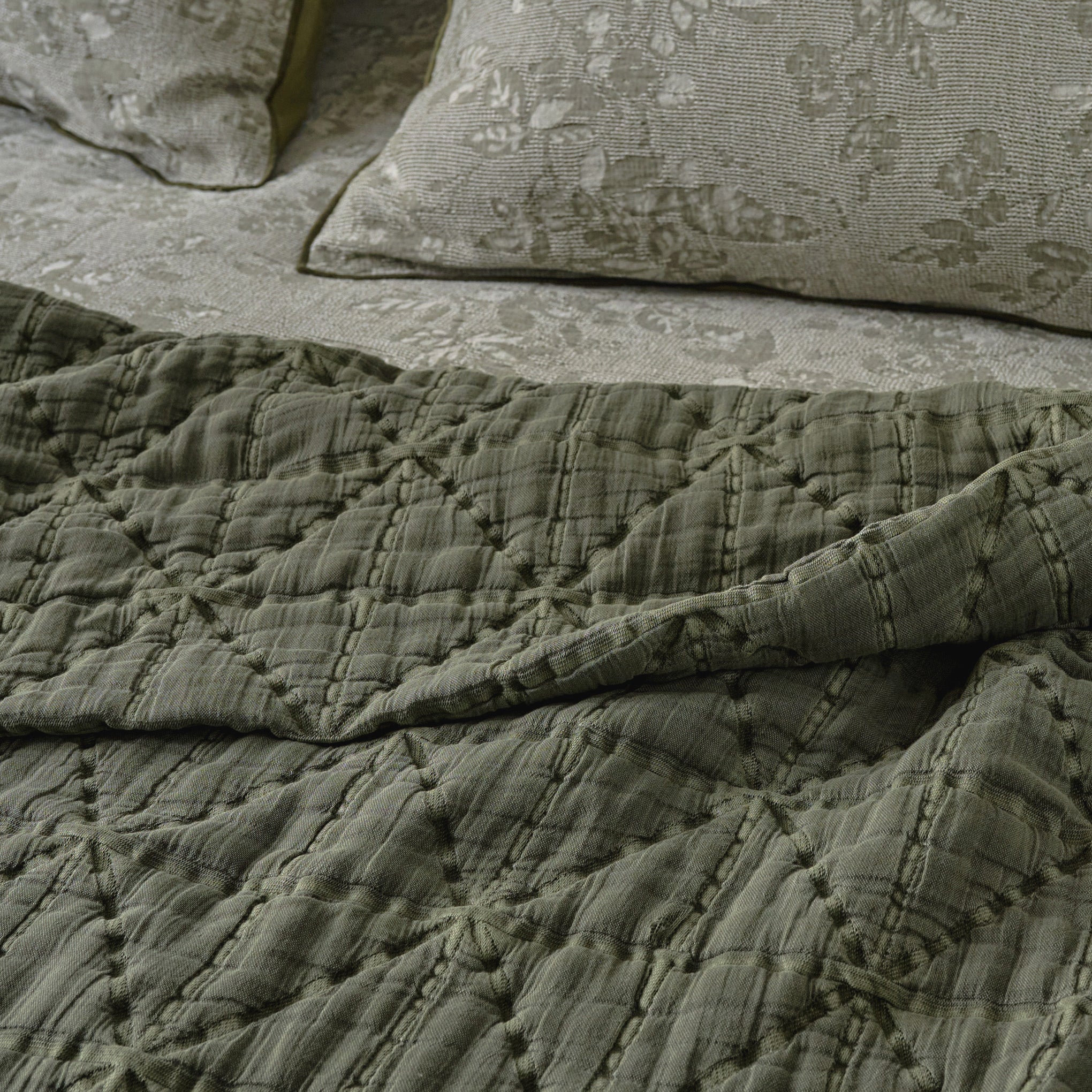 Sutton Winter Moss Matelasse Coverlet shown on bed up close
