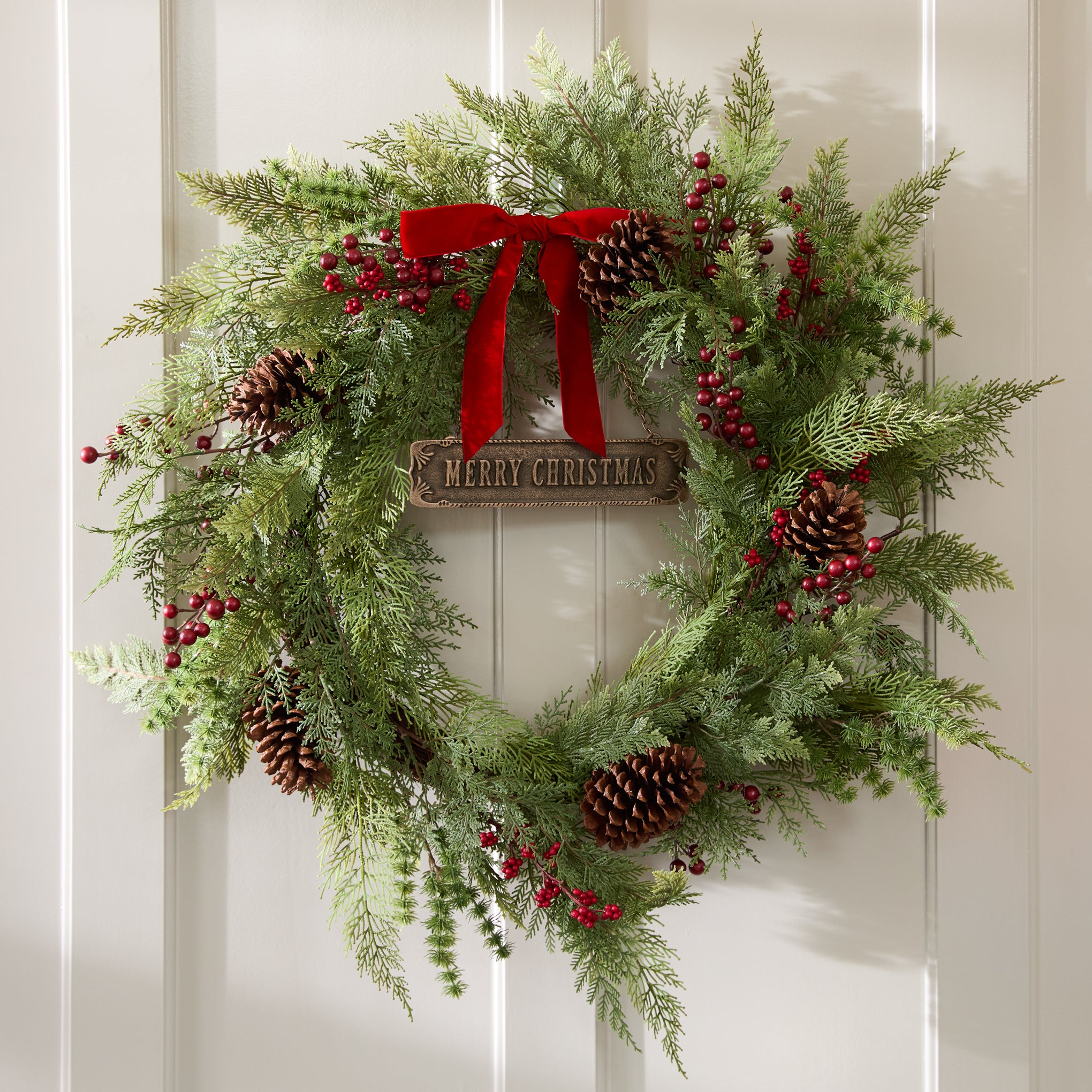 Real Touch Foraged Red Berry Pine Wreath on a wall