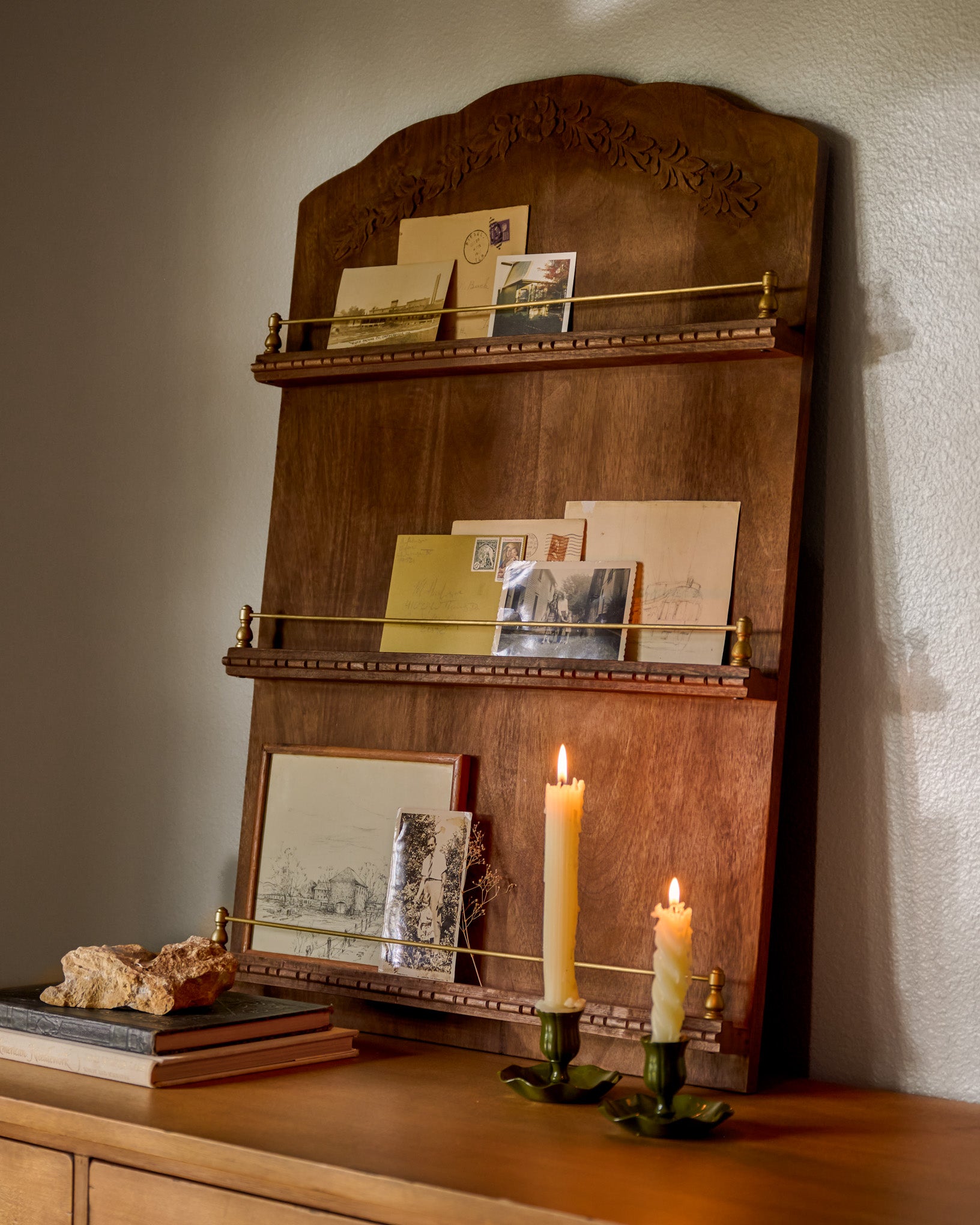 Gloria Carved Wood and Brass Display Shelf in a room