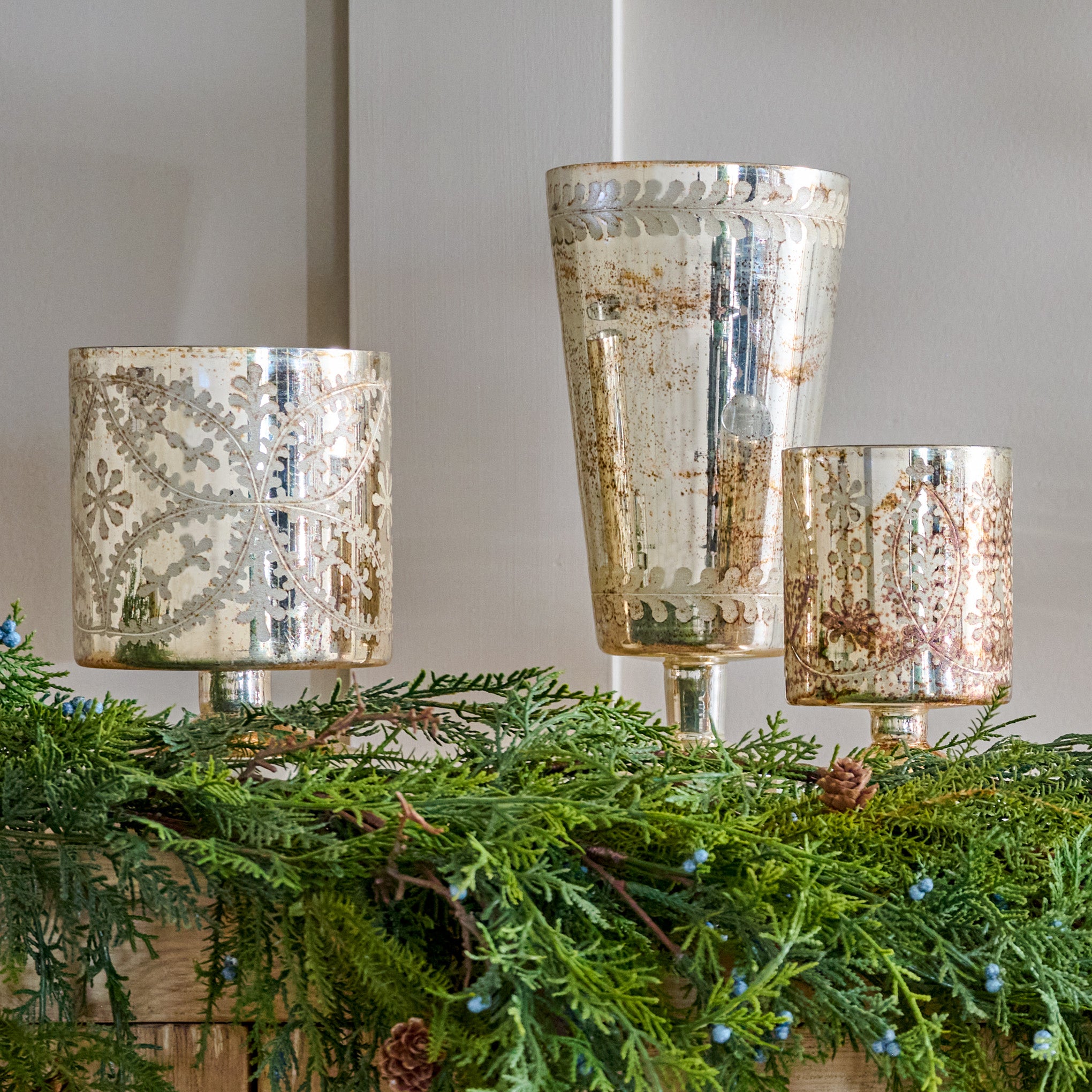 Burnished Mercury Glass Floral Hurricanes shown on mantel