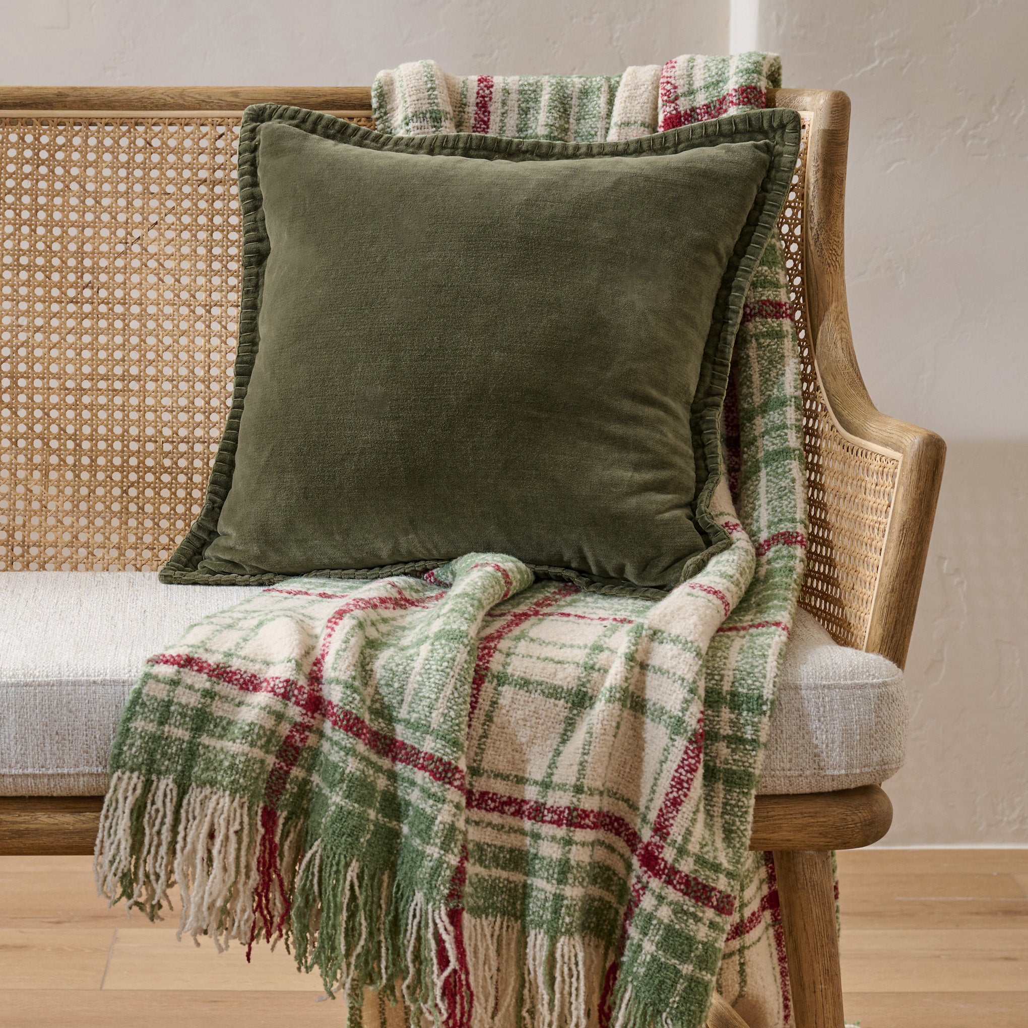Settle In Plaid Throw shown on bench with green pillow