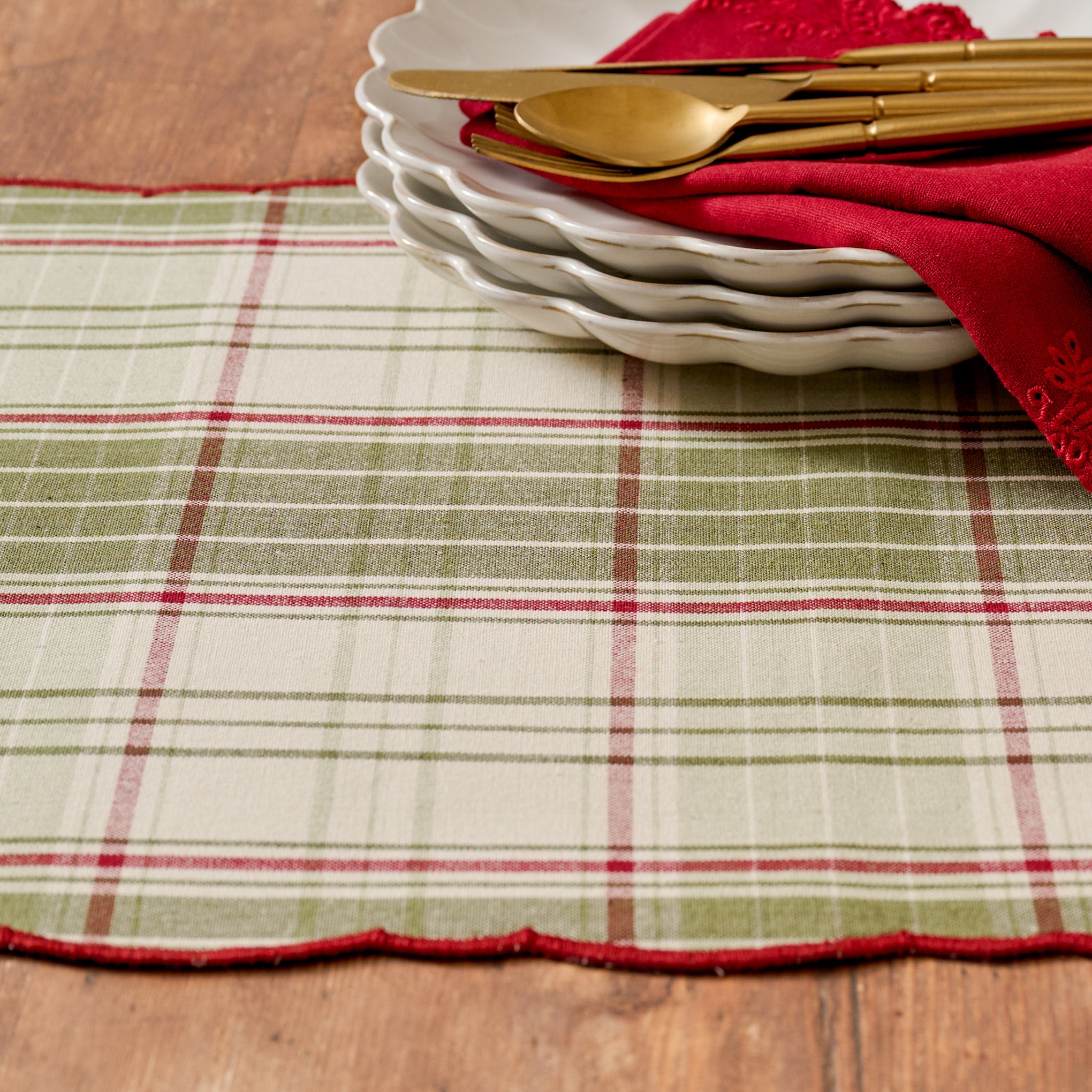 Magnoliass Festive Plaid Reversible Table Runner shown on table with green plaid side facing up - up close