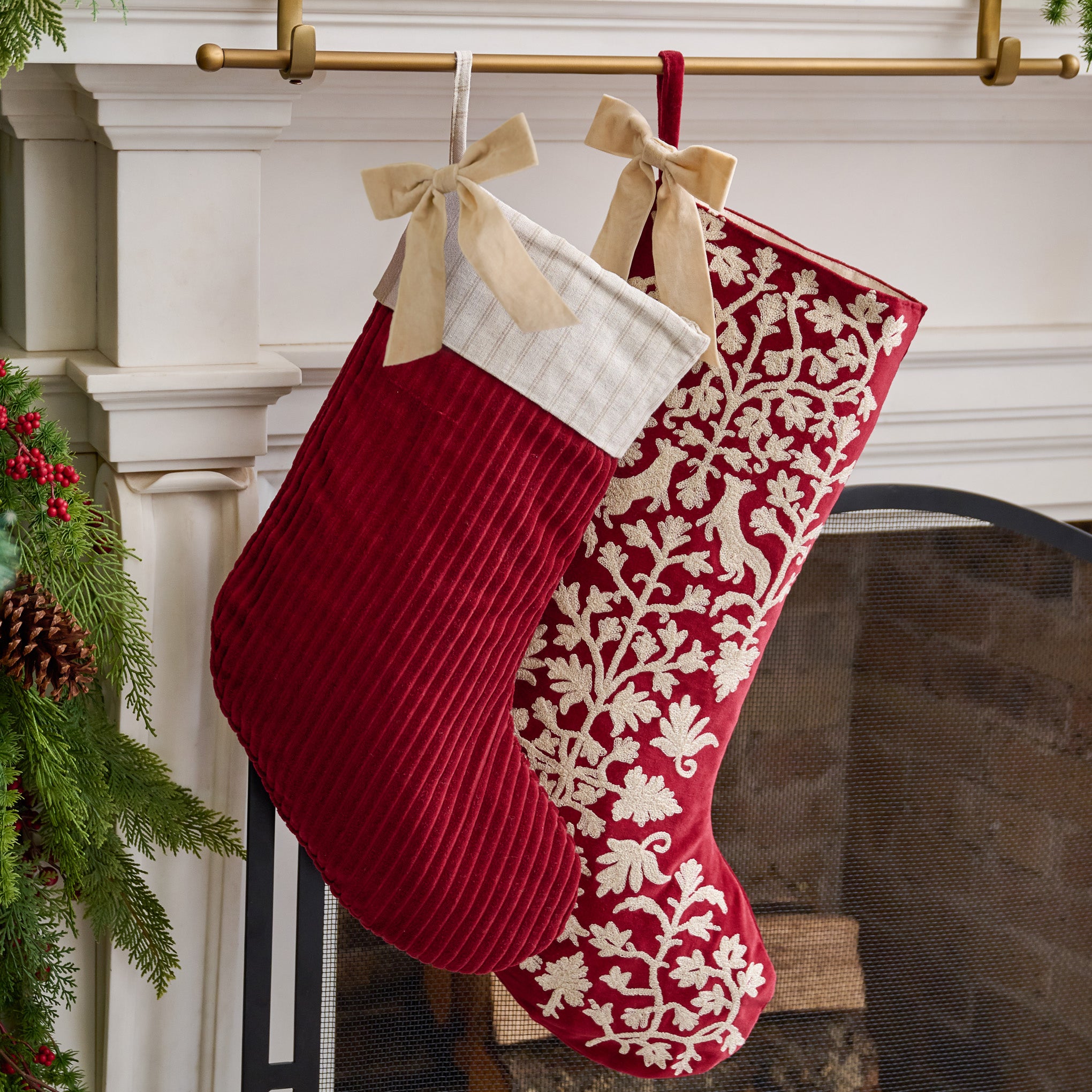 Syrah Enchanted Forest Embroidered Velvet Stocking shown hung above mantel with other stocking