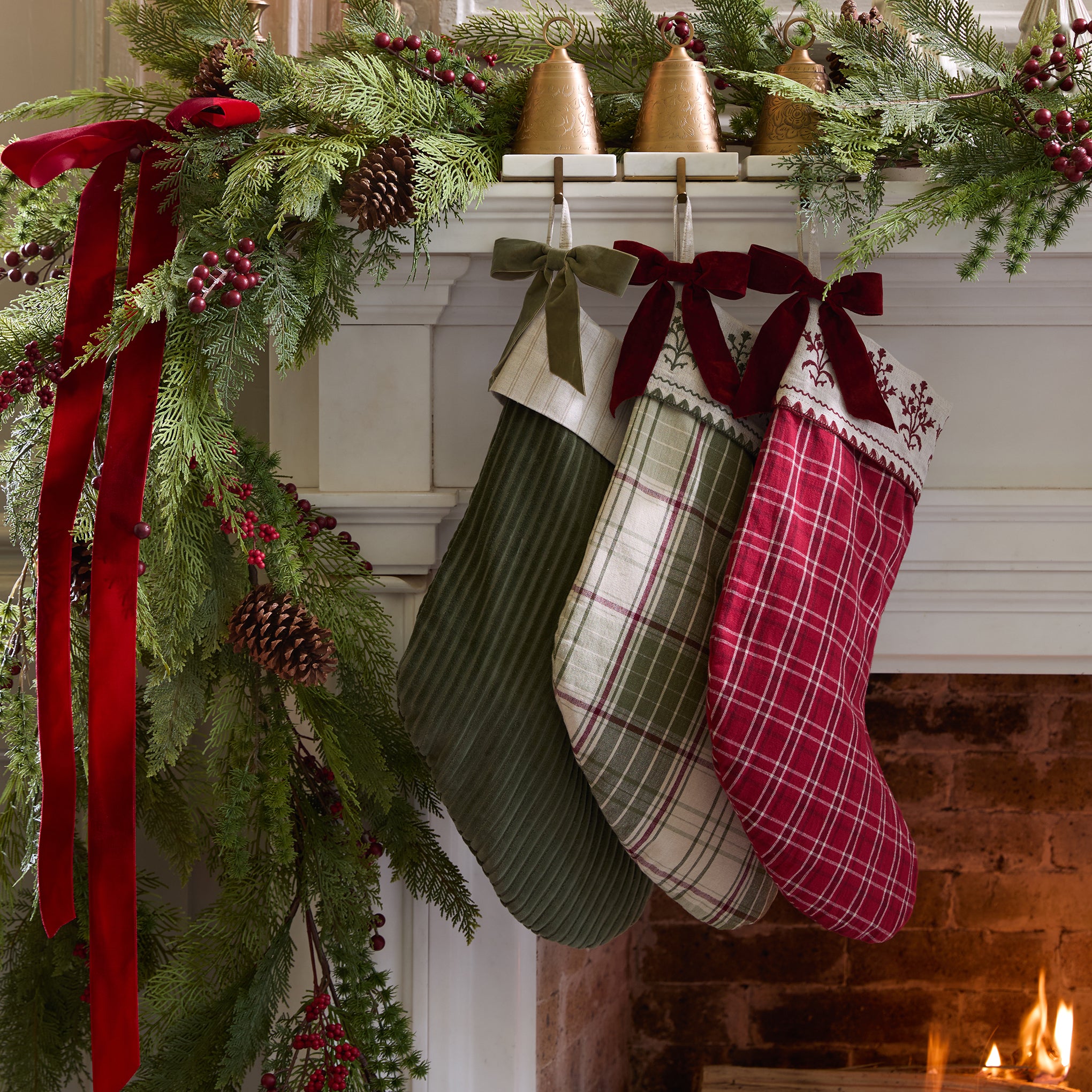 Winter Moss Channel Velvet Stocking shown hung on mantel with other stockings