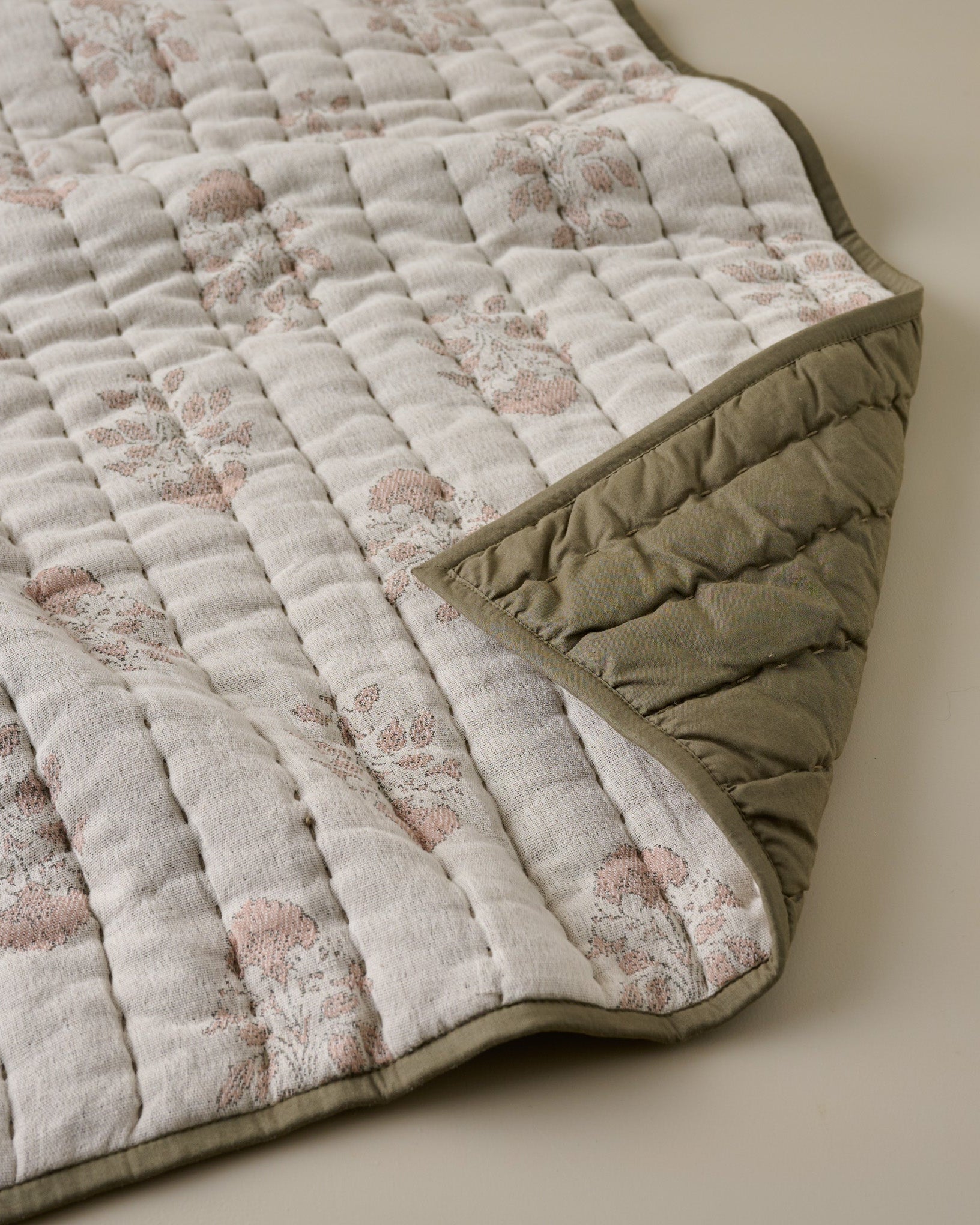 Floral Jacquard Kantha Quilt close up with olive green reversible
