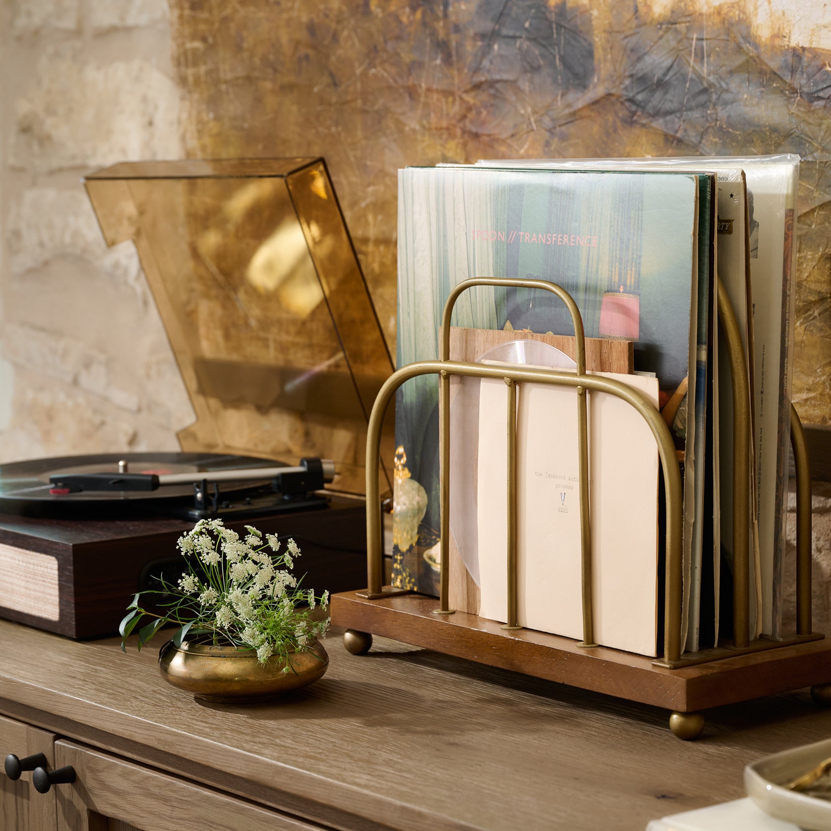 Short Antique Brass and Wood Media Stand holding vinyl records in a room