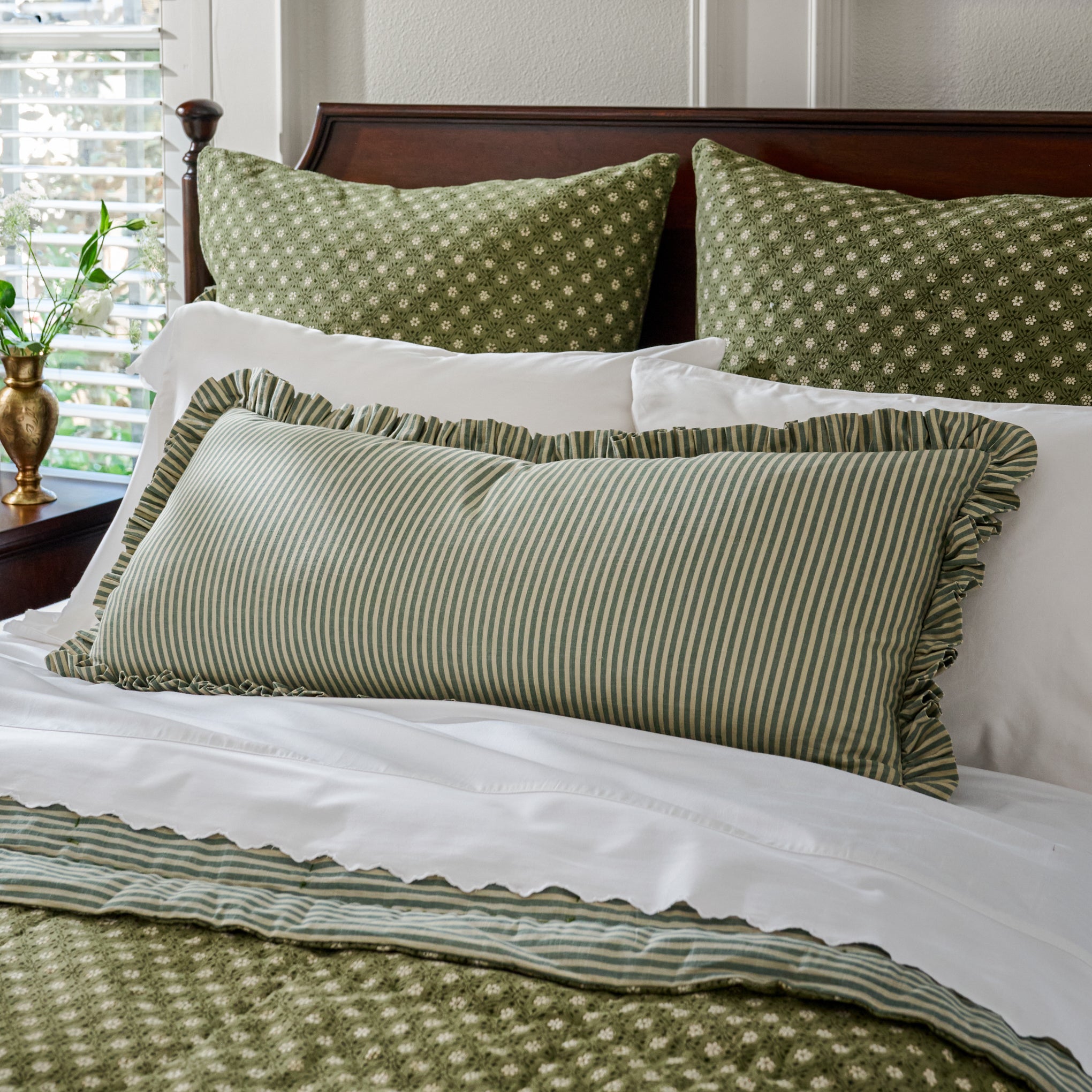 Thea Reversible Lumbar Pillow (large) stripe side featured on bed