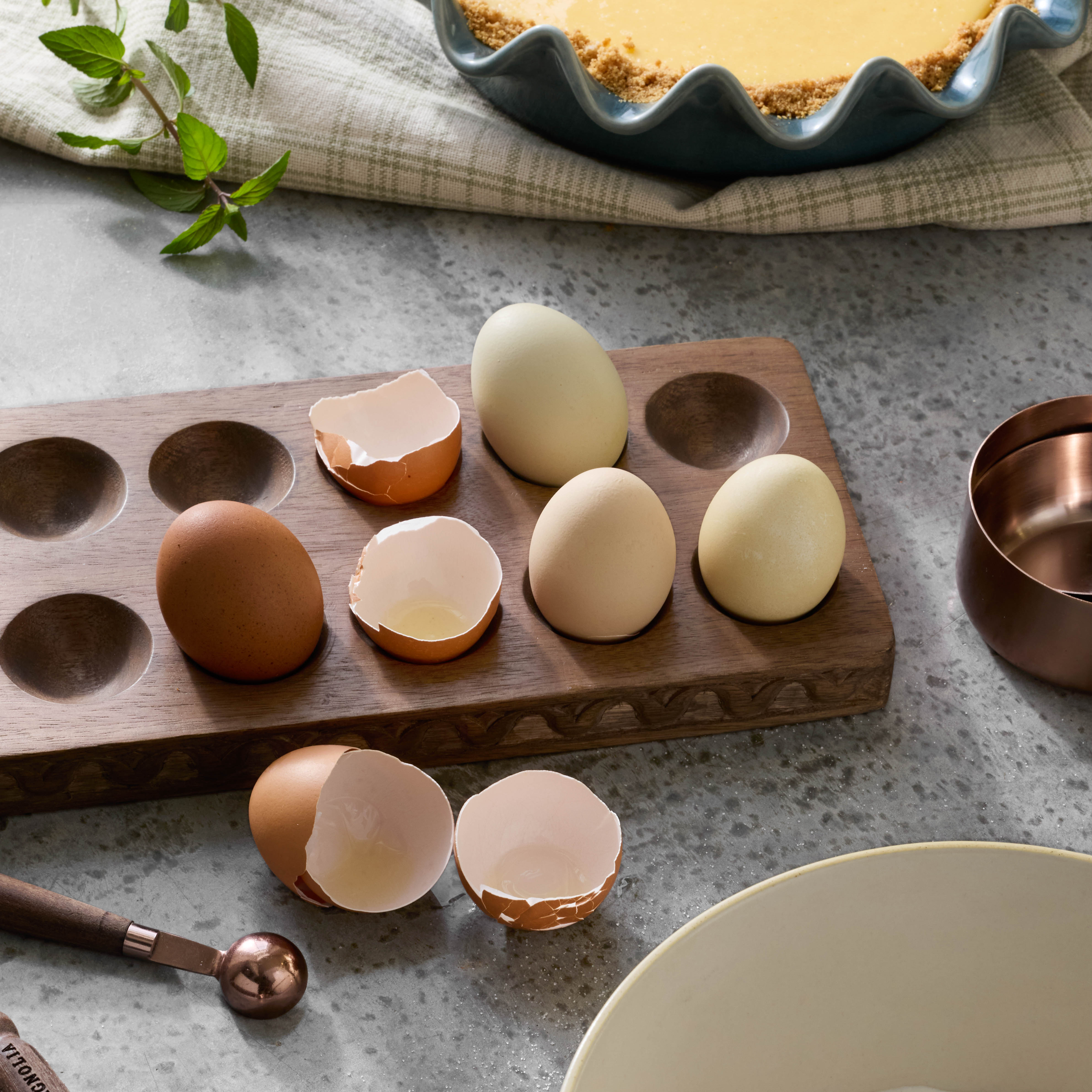 Antiqued Wood Tulip Carved Edge Egg Tray on counter with eggs placed on top
