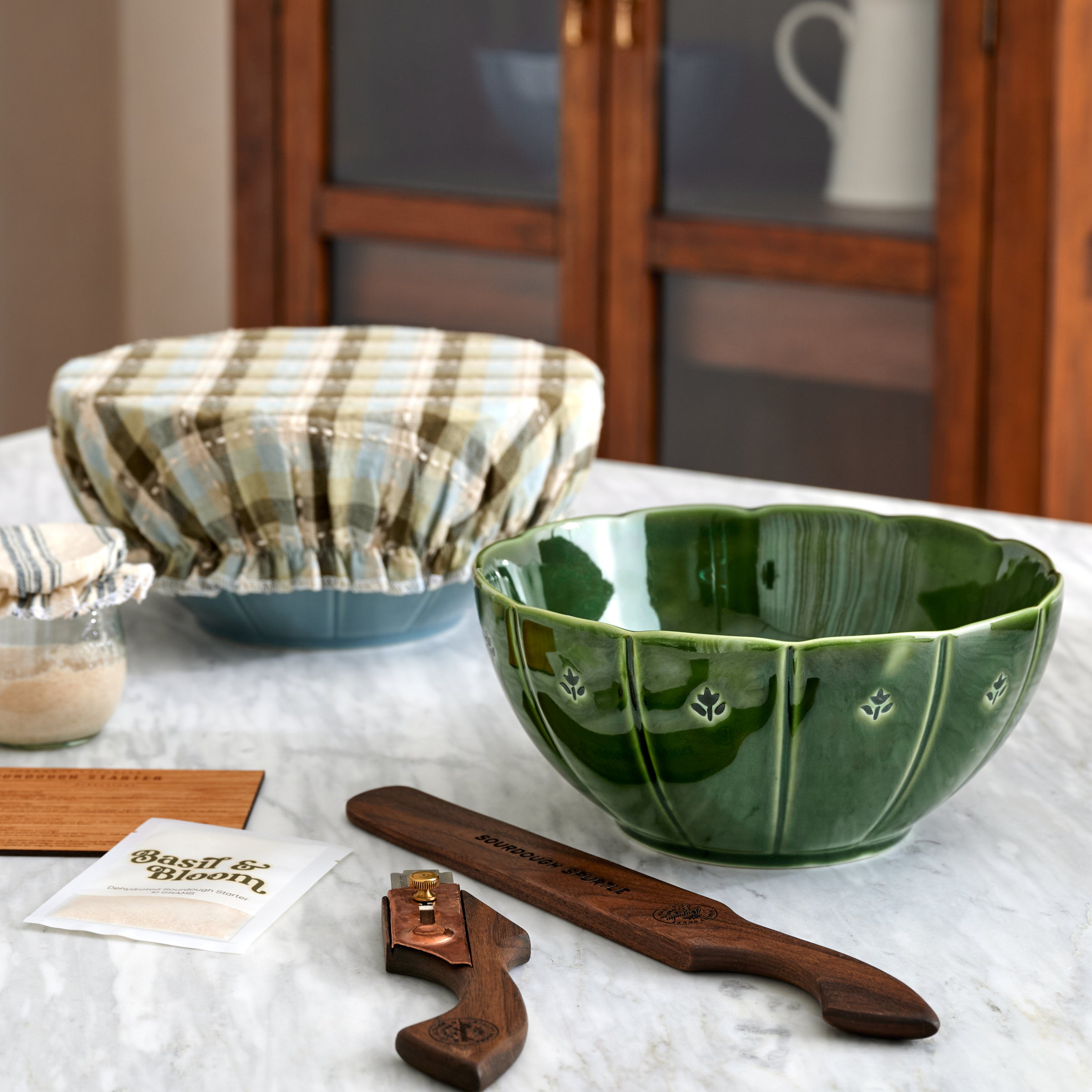 Luna Scalloped Mixing Bowl Set of Three with kitchen utensils