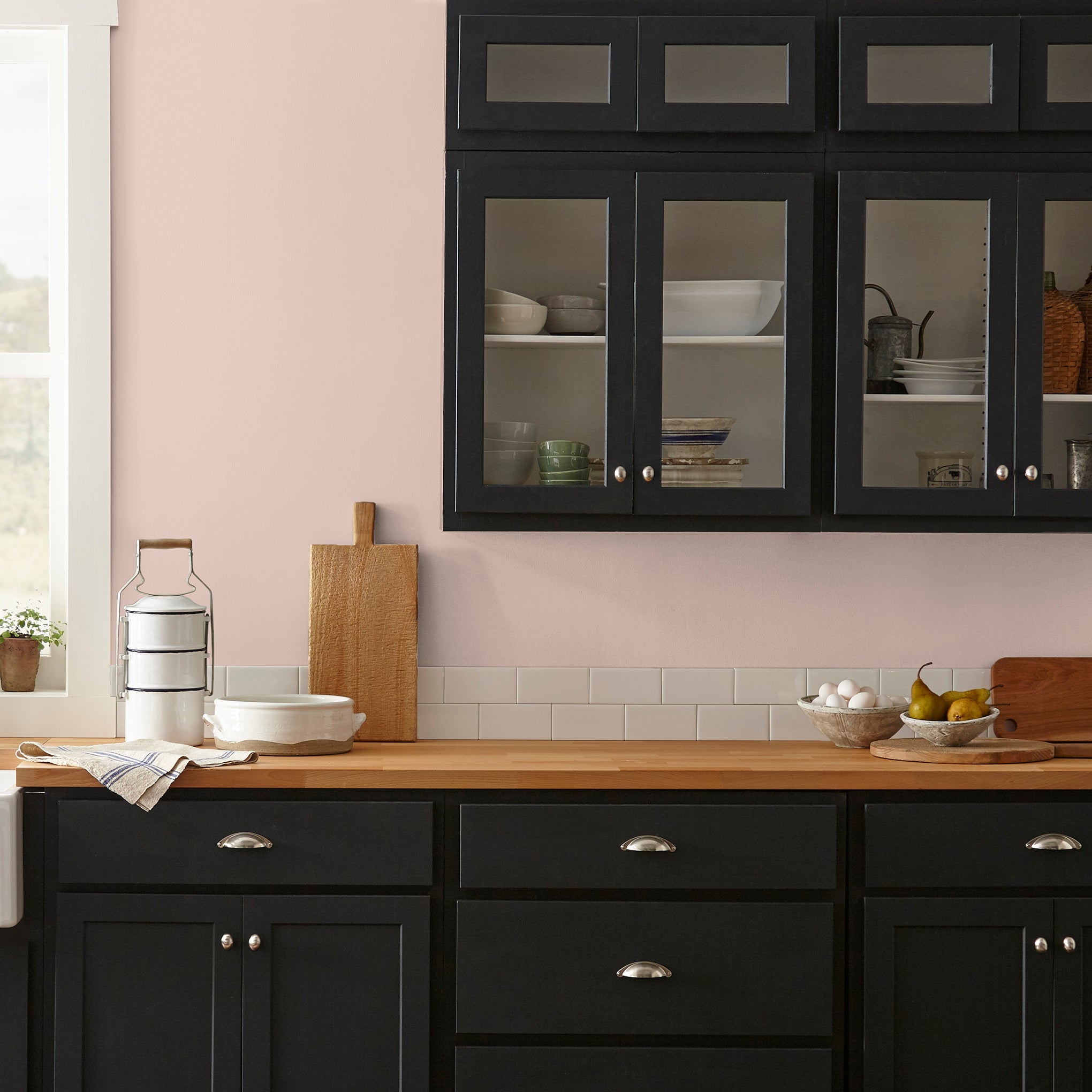 Pale neutral pink with accents of peach paint named ella rose shown painted on kitchen wall
